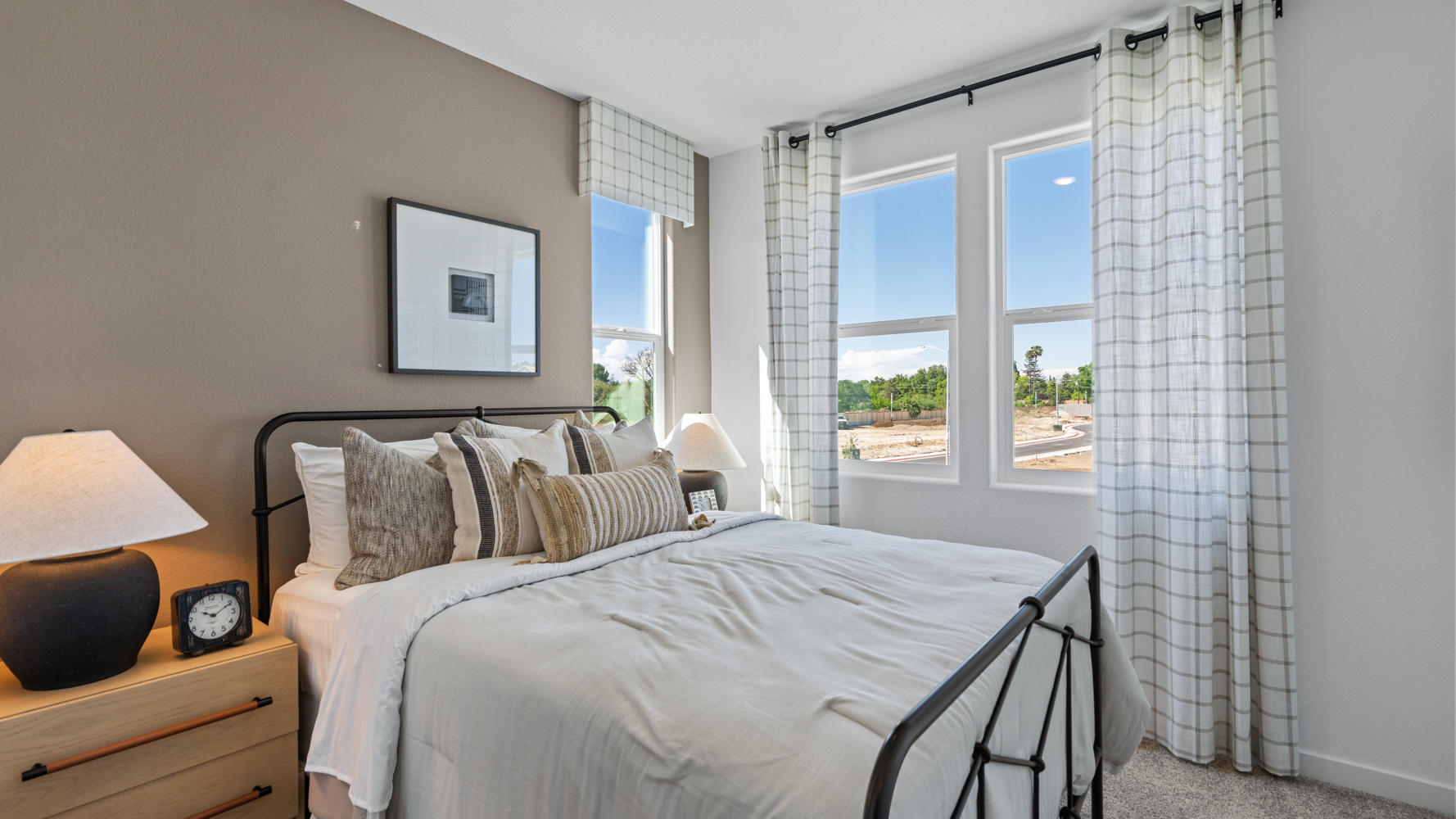 A bed with a white bed spread.