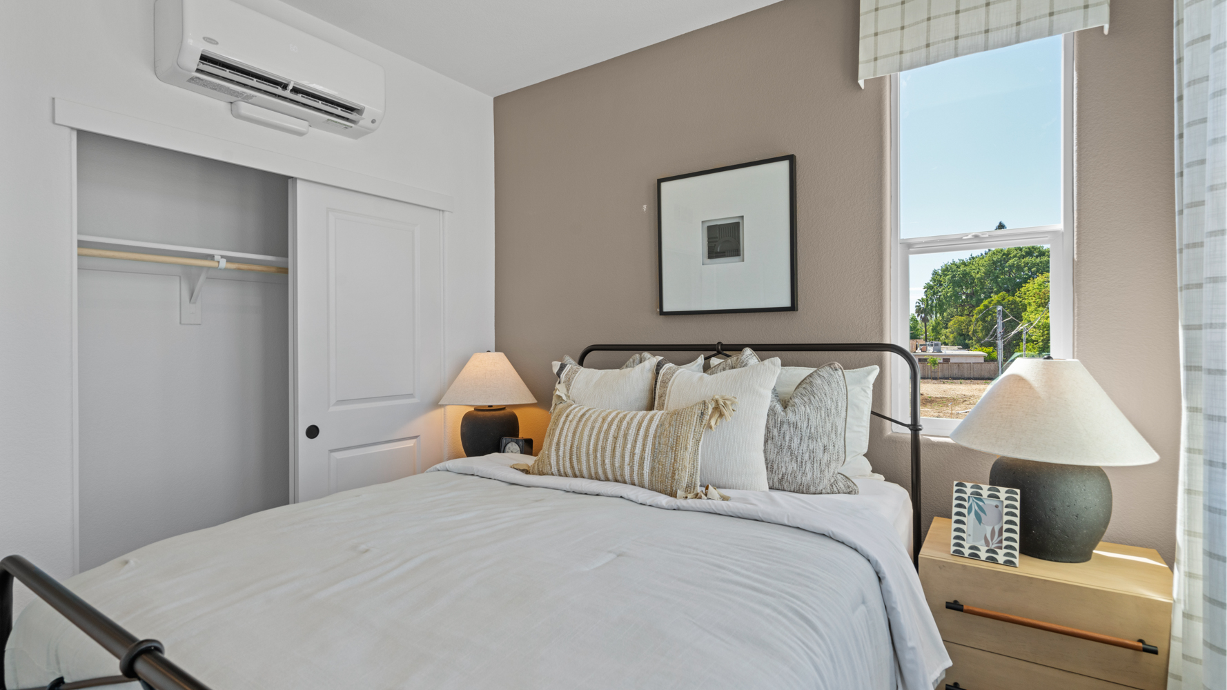 A bed with a white bed spread.