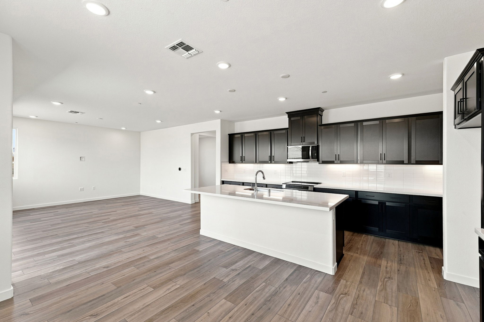 A kitchen with black cabinets.