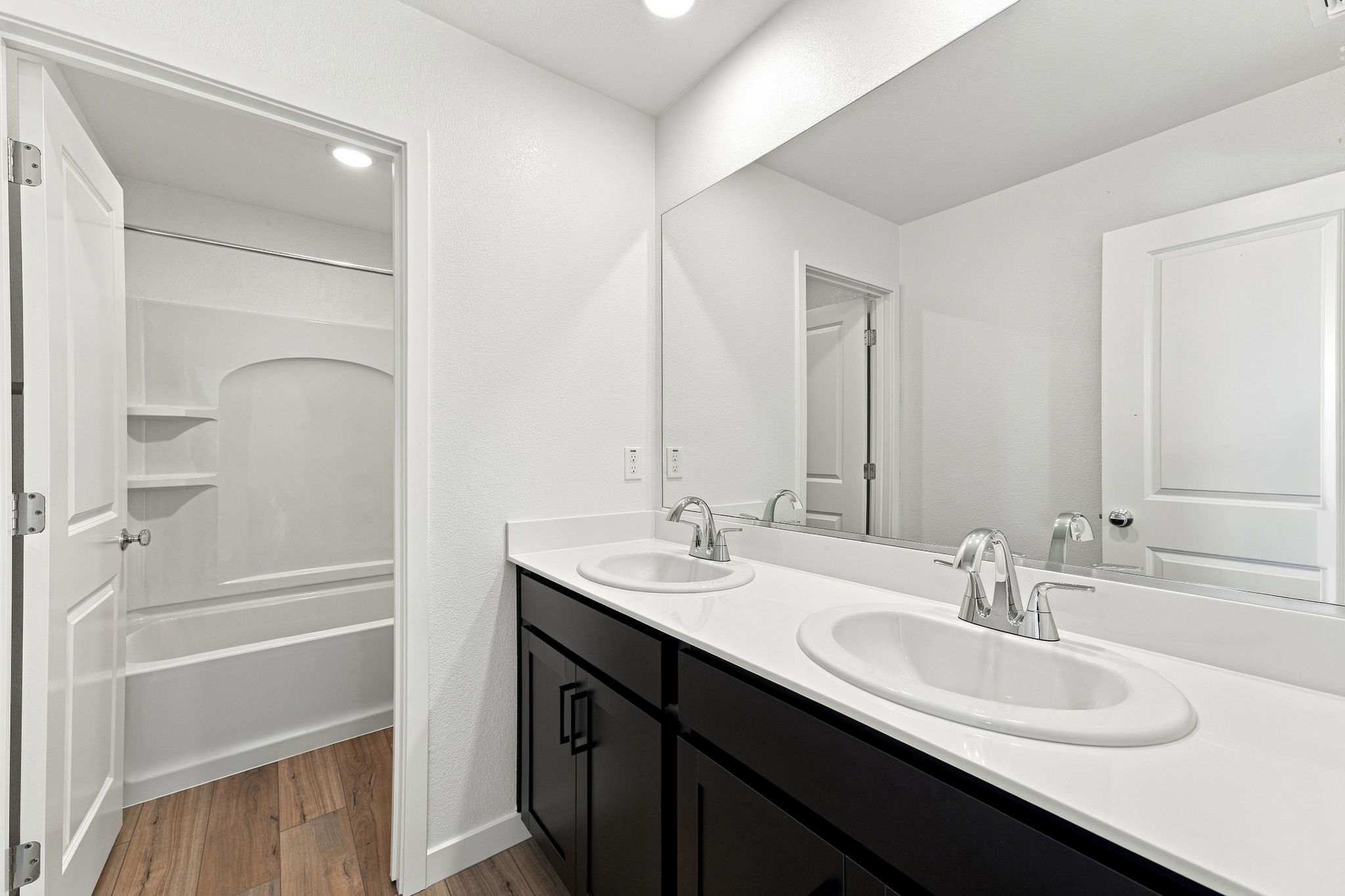 A bathroom with a sink and a shower.
