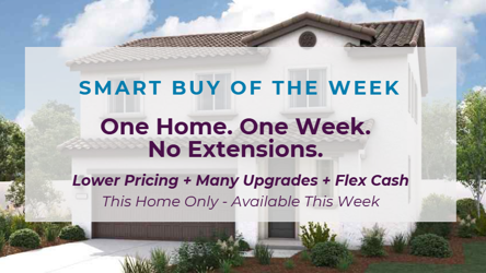 A white building with a sign in front of it.