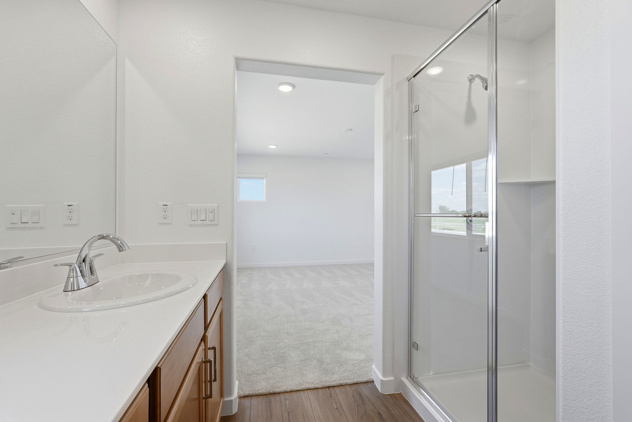 A bathroom with a sink and shower.