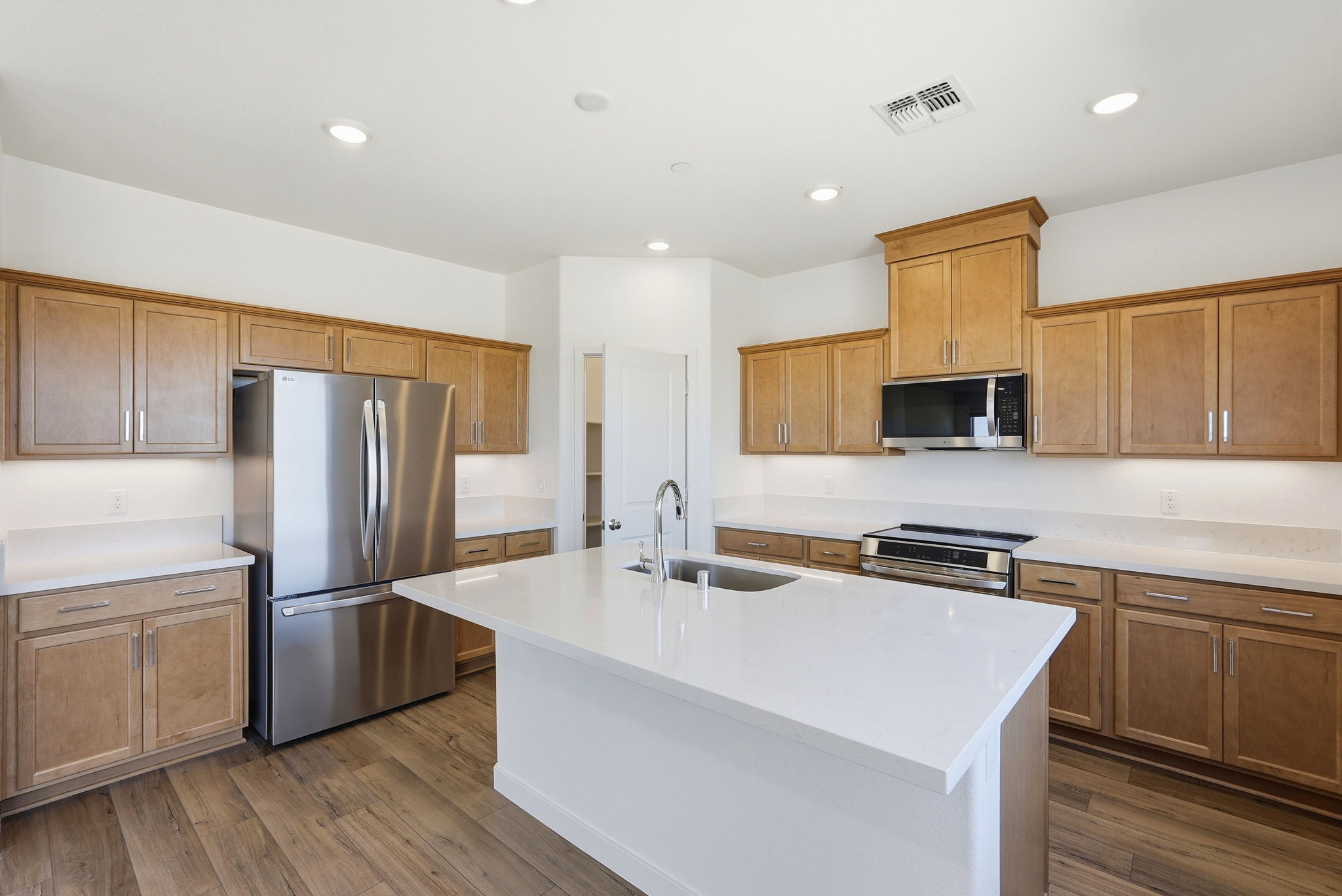 A kitchen with wooden cabinets.