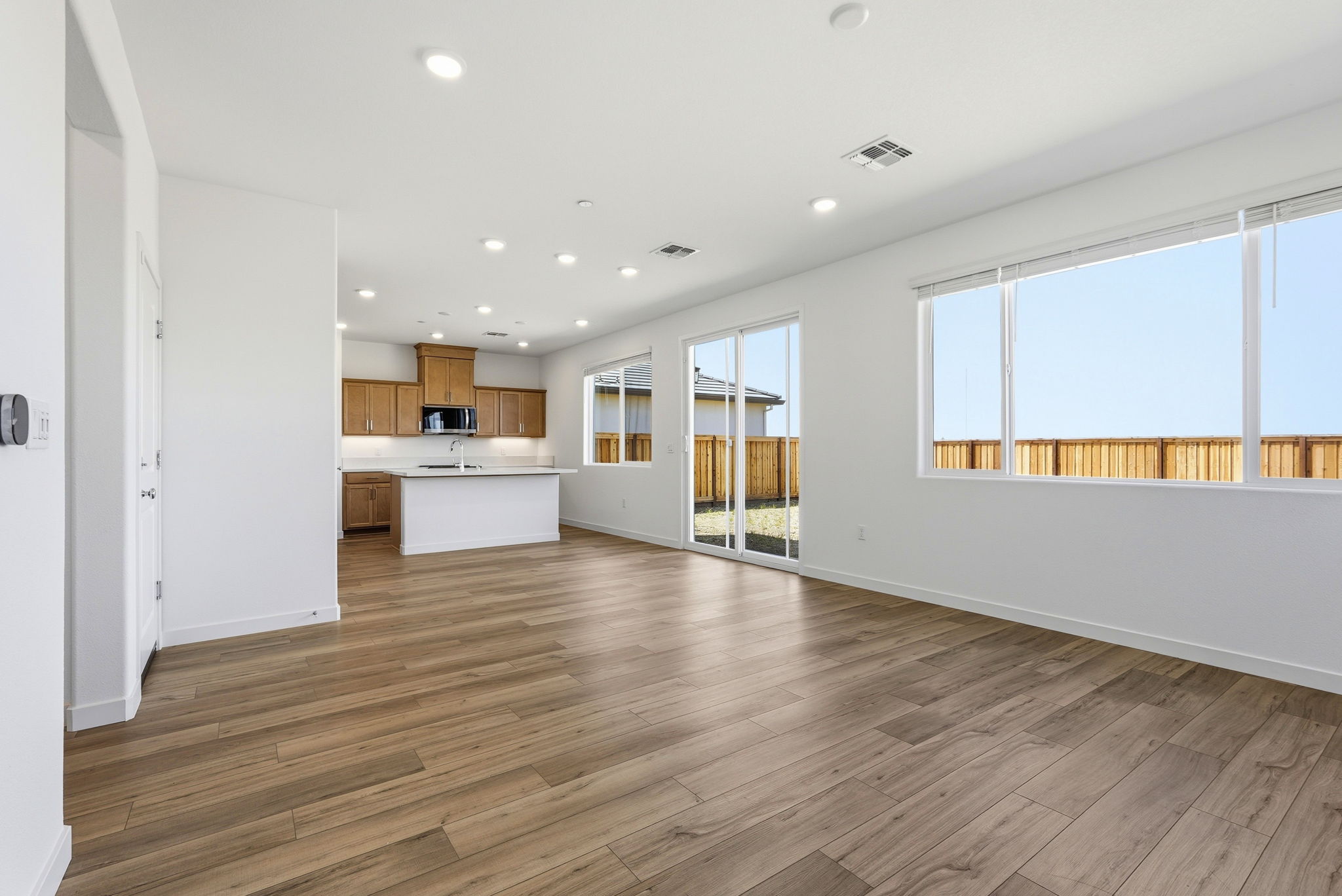 A large kitchen with a wood floor.