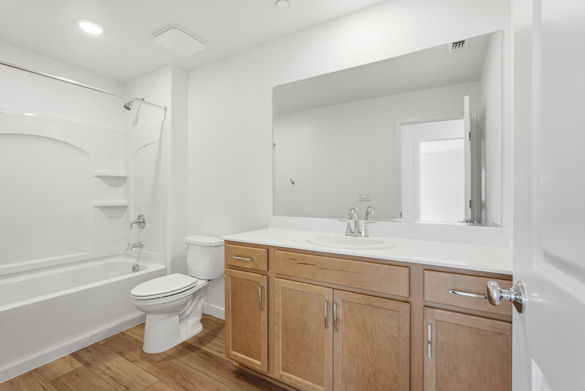 A bathroom with a tub toilet and sink.
