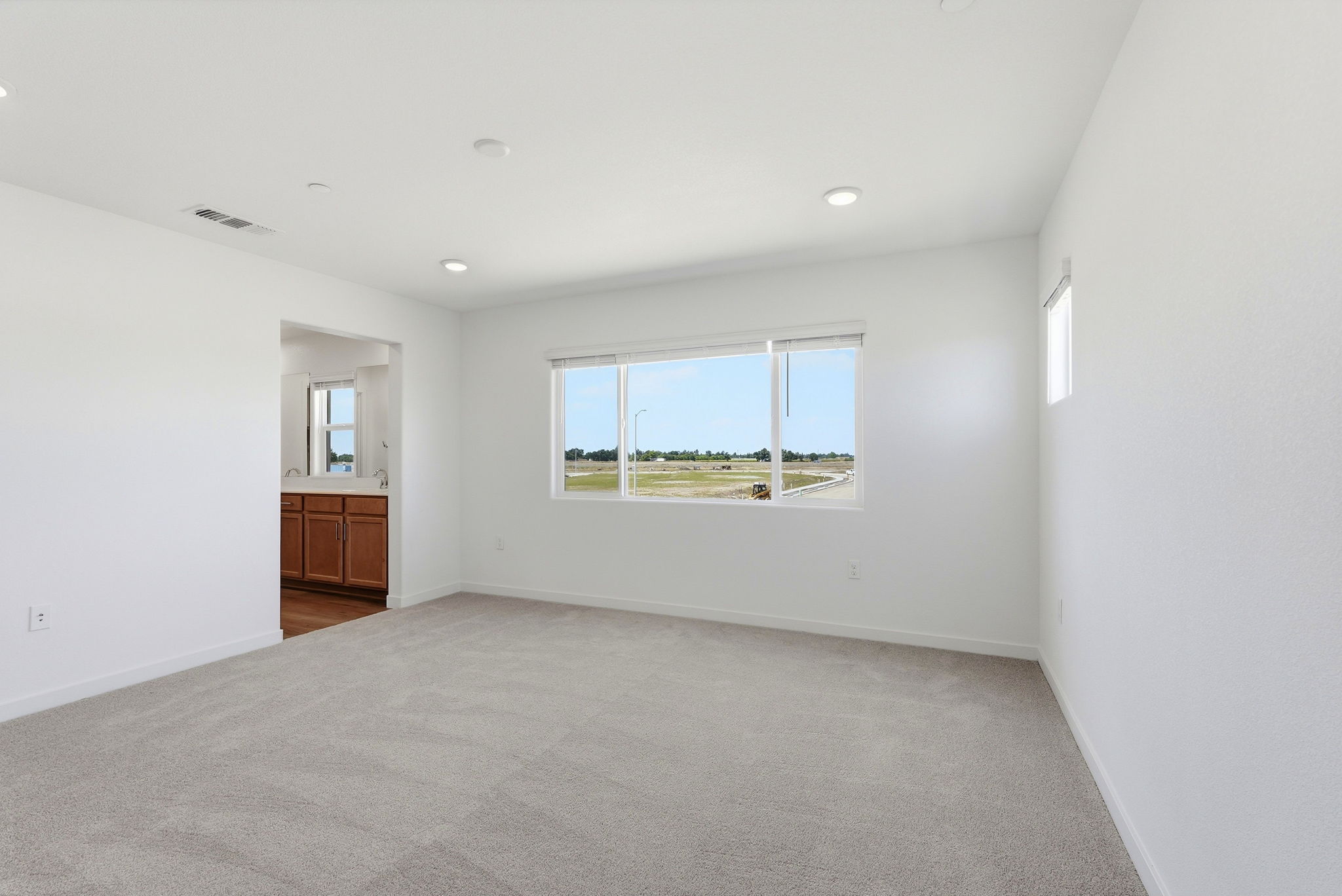 A room with a window and a carpet.