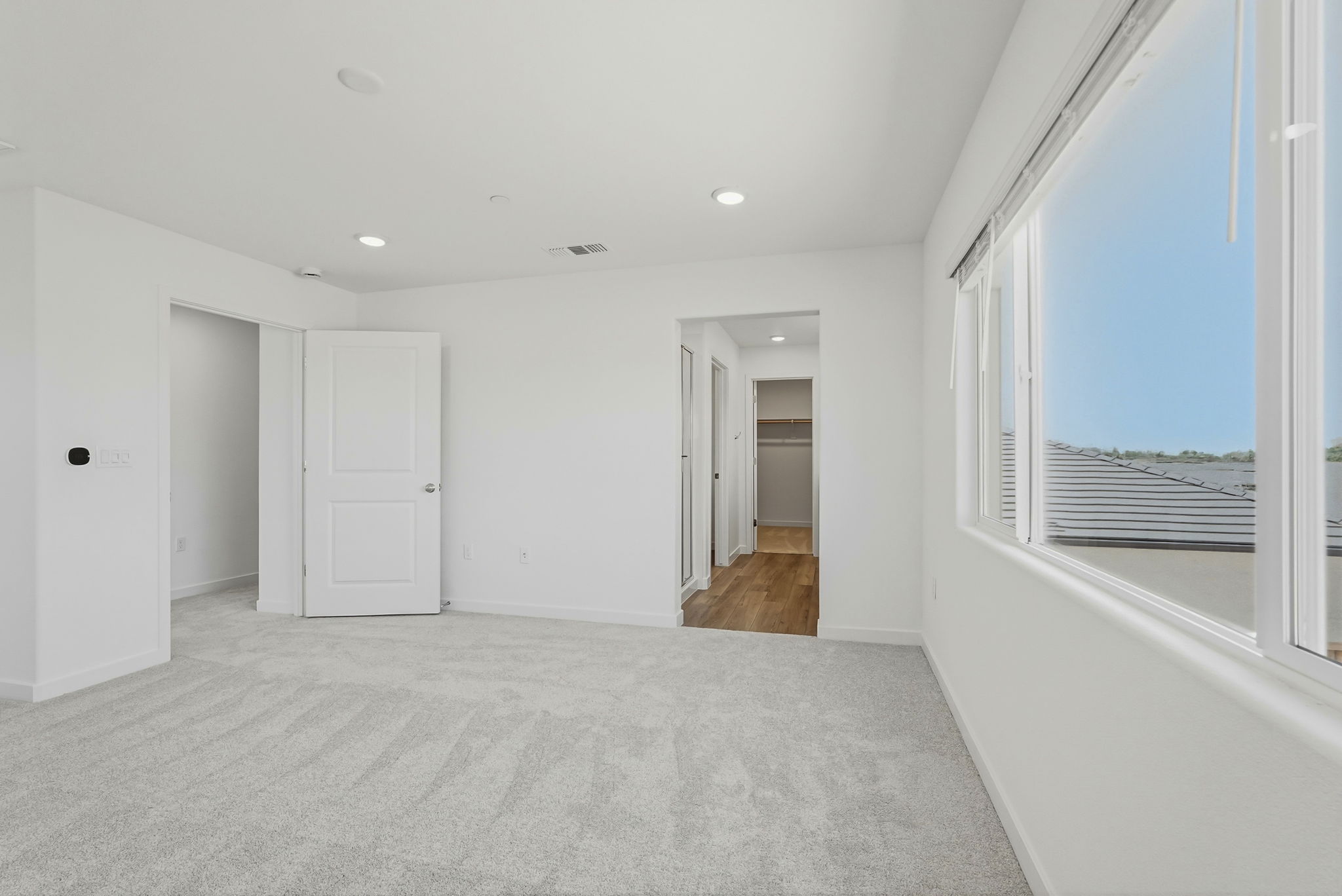A hallway with white doors.
