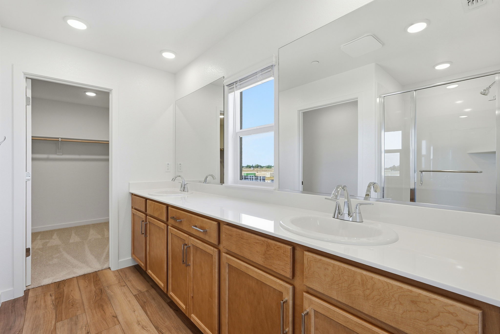 A bathroom with a large mirror.