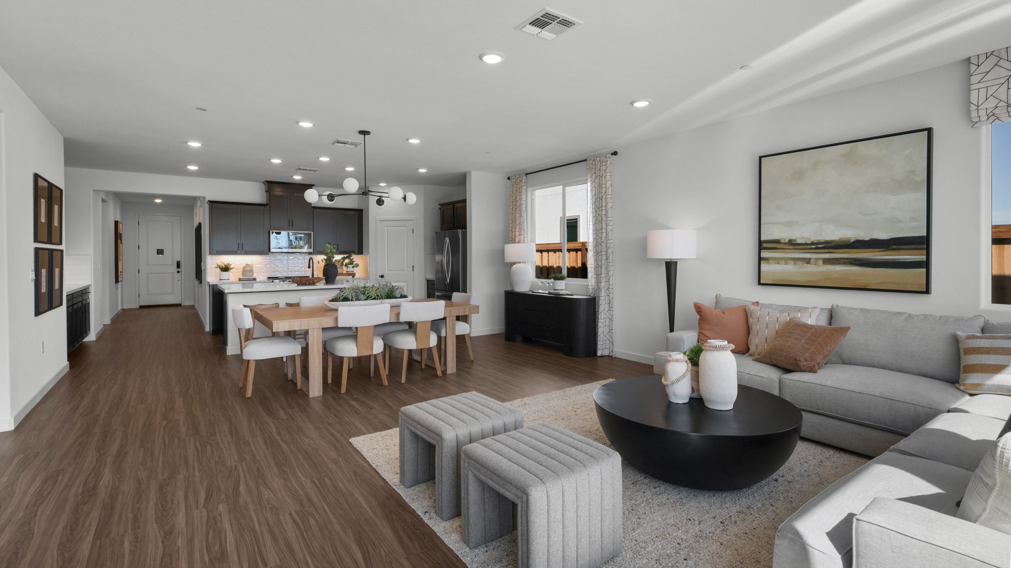 A large living room with a large dining table and couches.