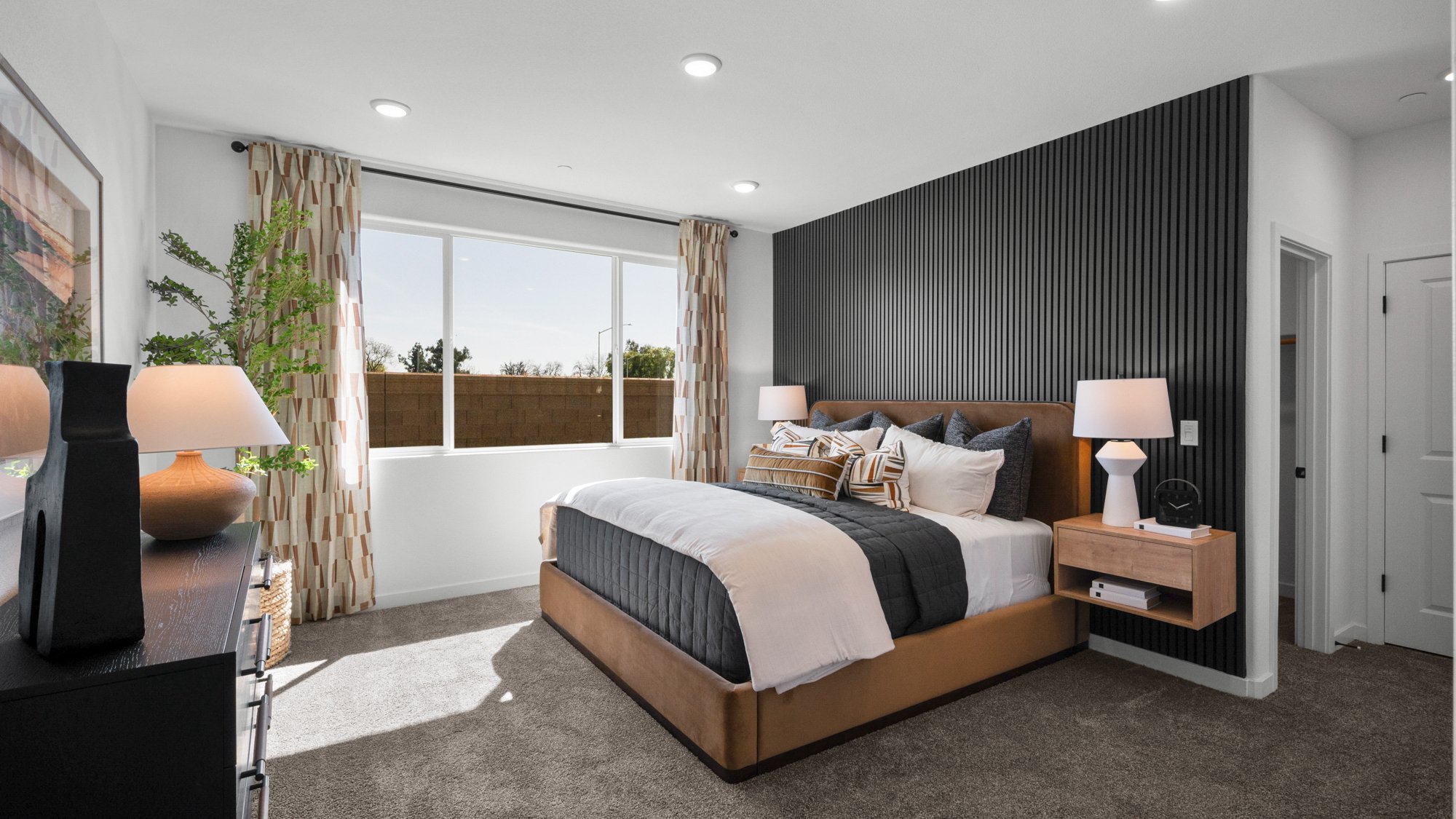 A bedroom with a large window.