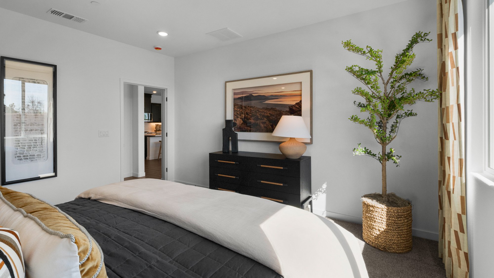 A bedroom with a bed and a lamp.