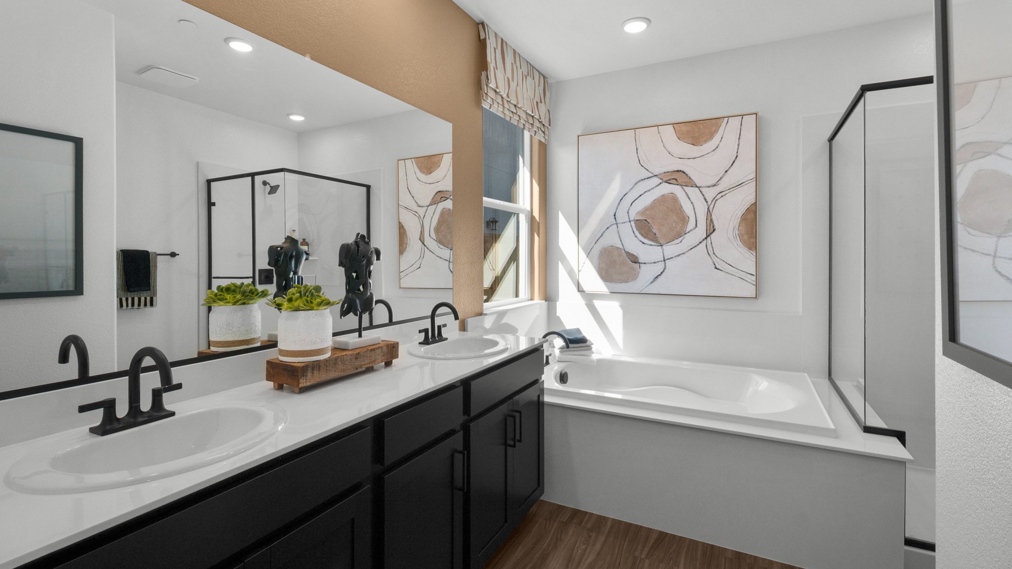A bathroom with a tub sink and a mirror.