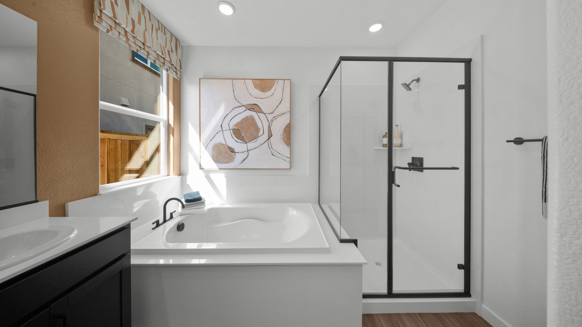 A bathroom with a sink and a shower unit.