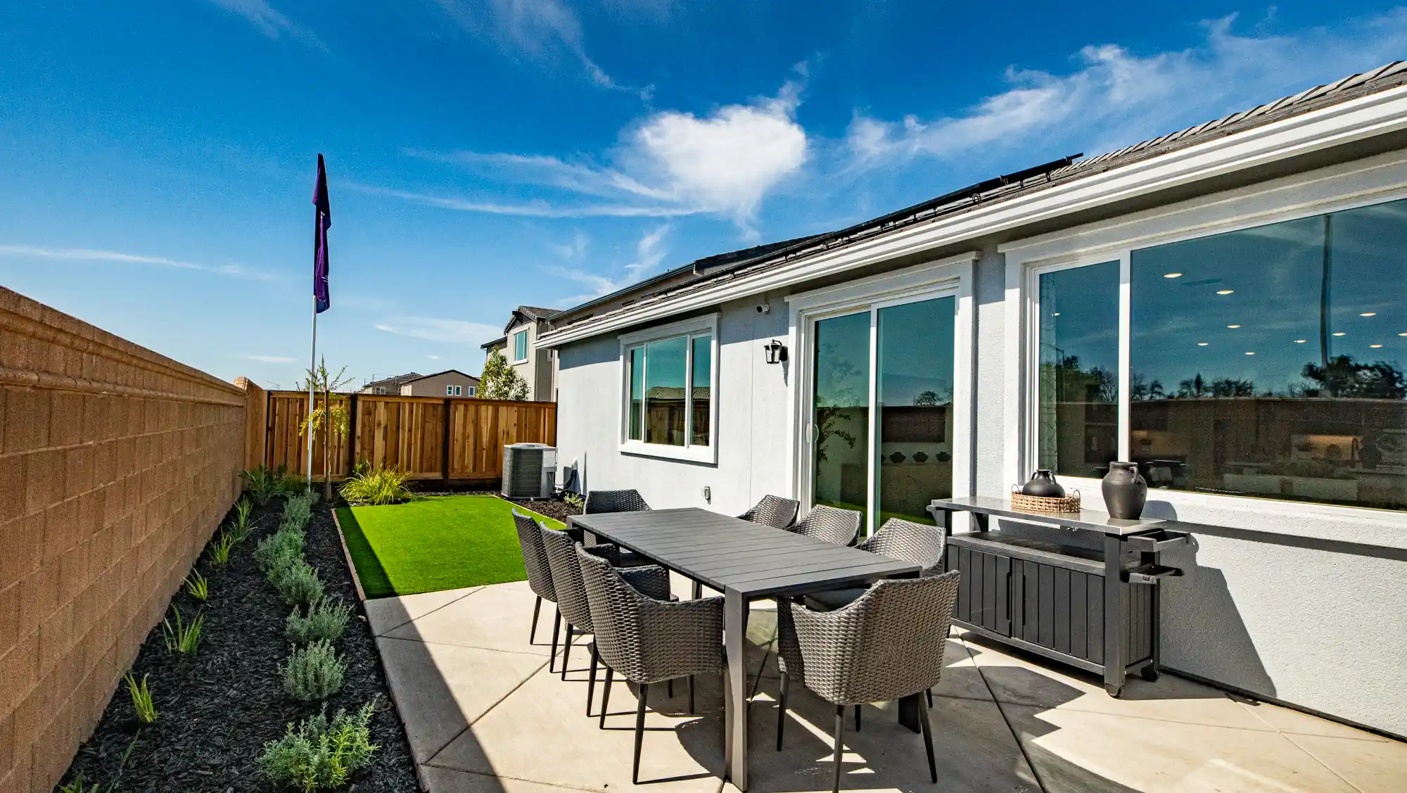 A patio with a table and chairs.