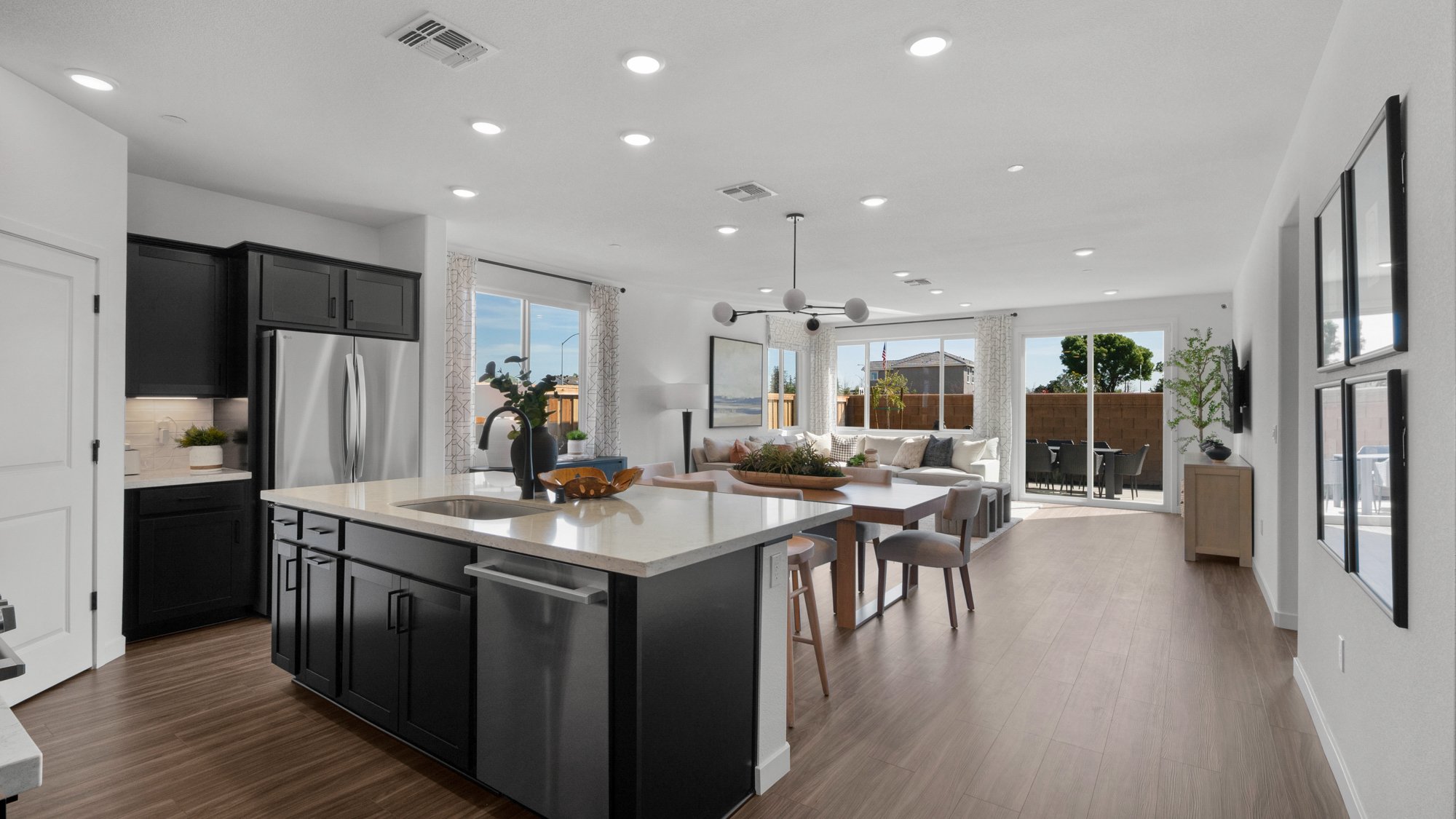 A kitchen with black cabinets.