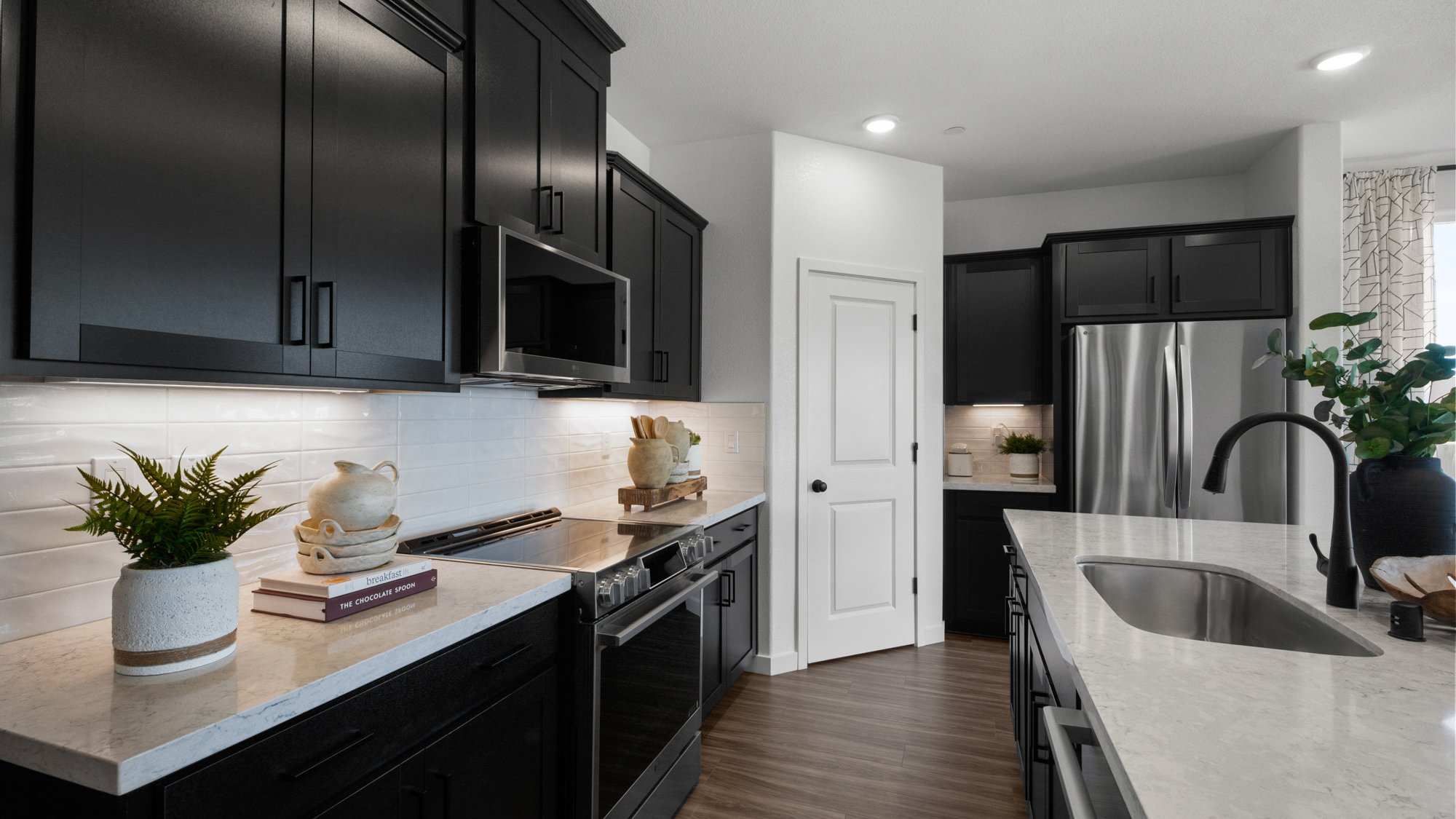 A kitchen with black cabinets.