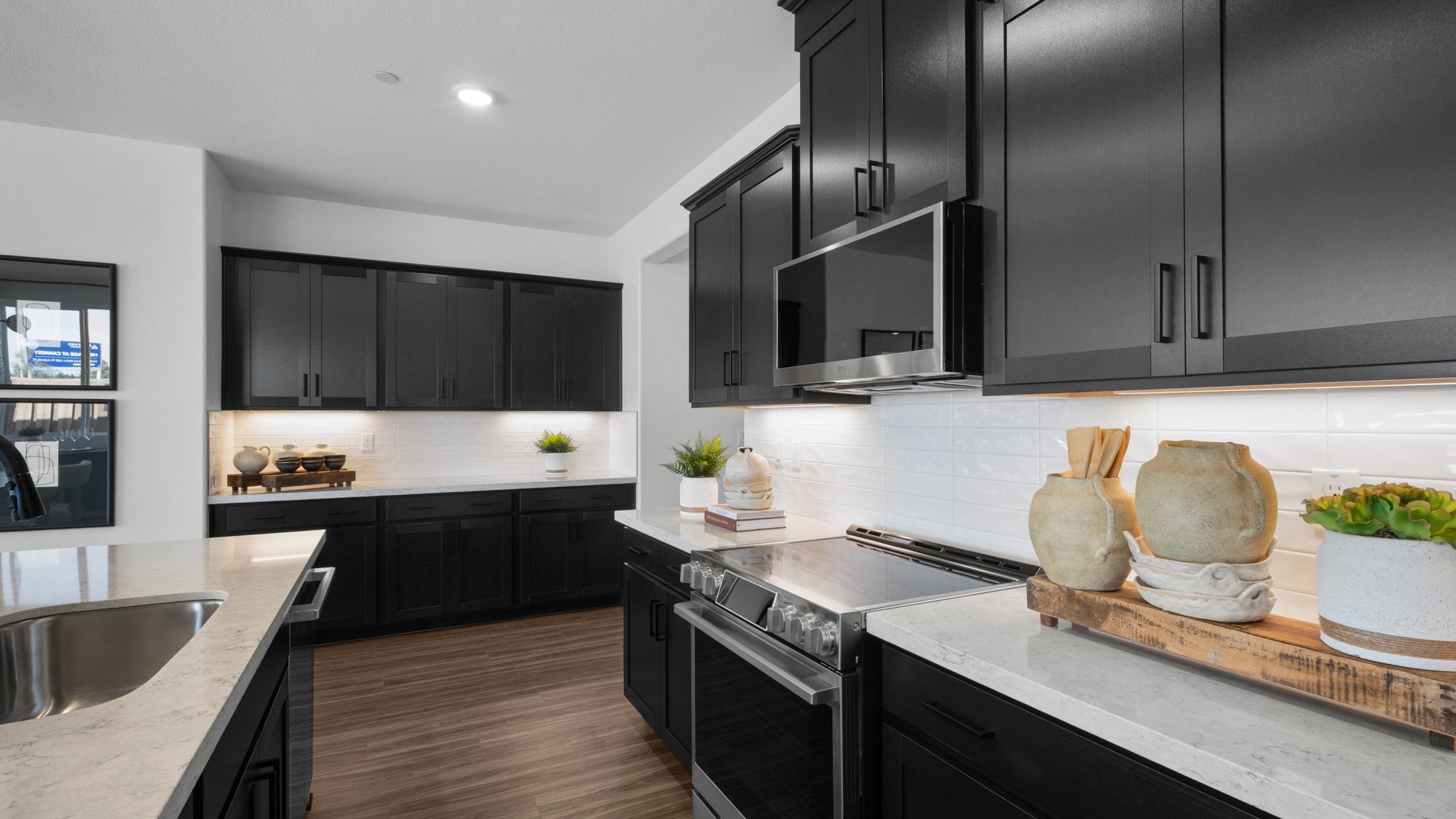 A kitchen with black cabinets.