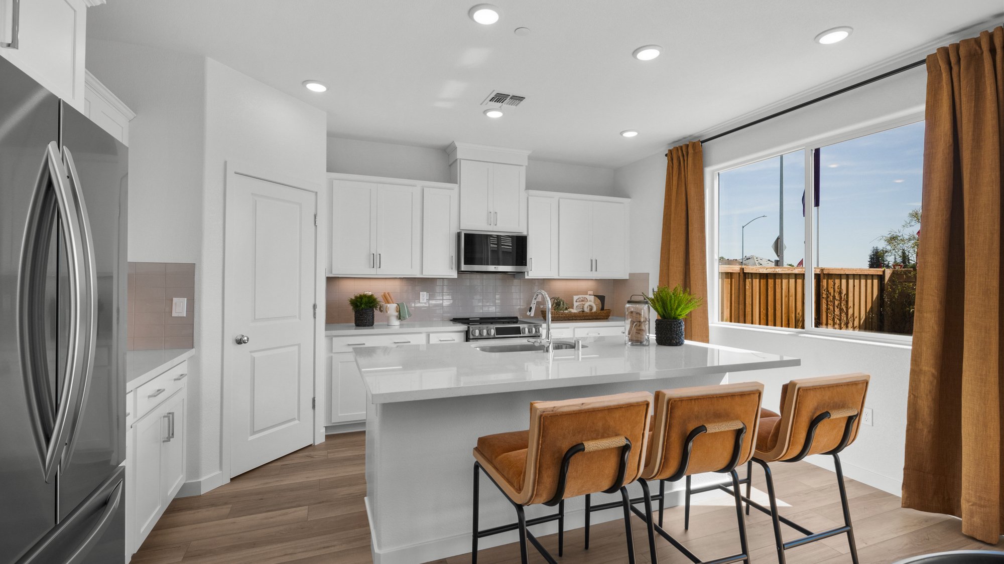 A kitchen with a table and chairs.