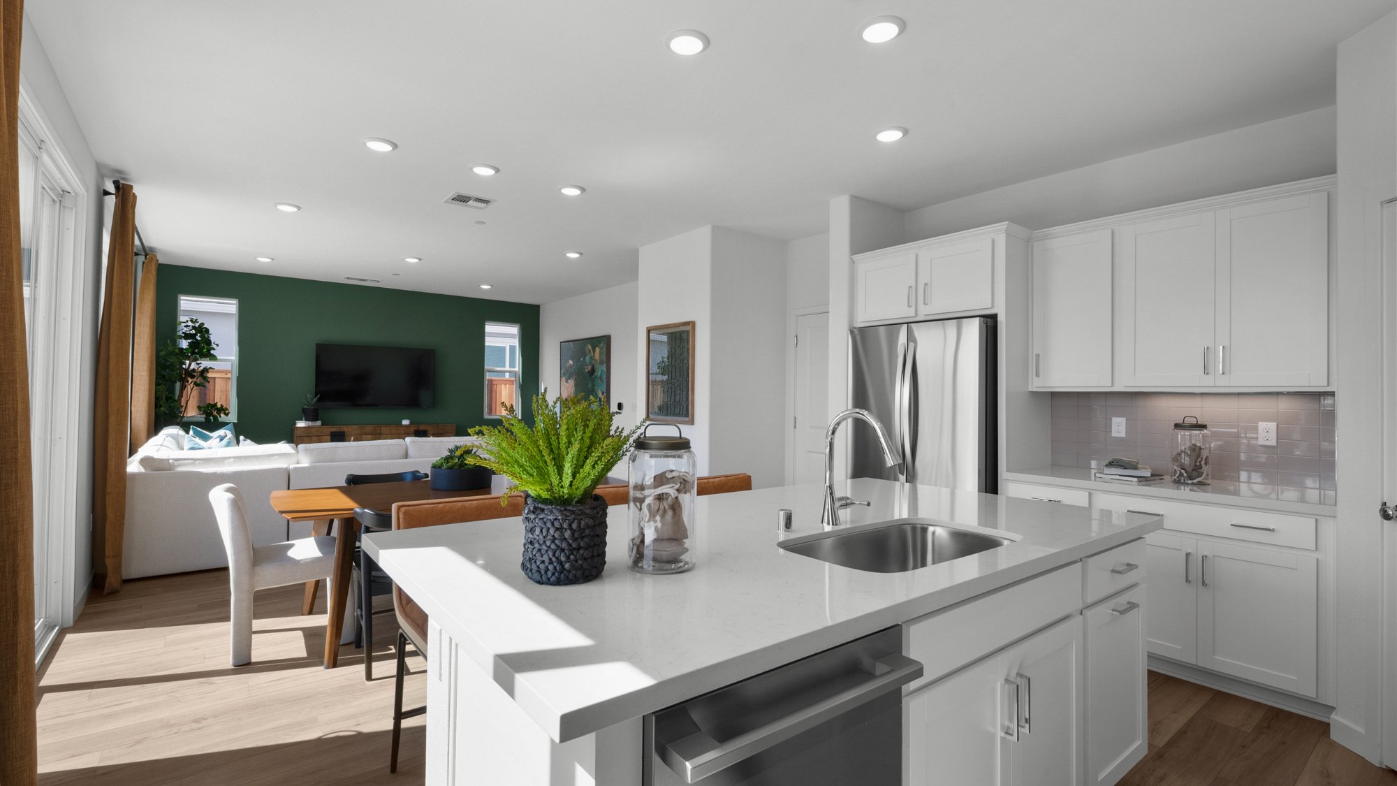 A kitchen with white cabinets.