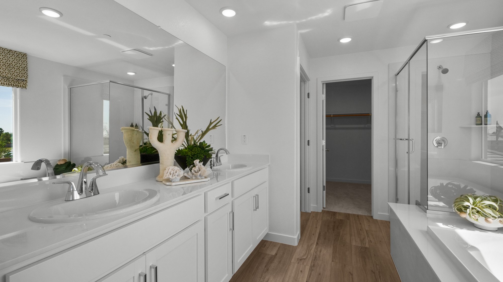 A bathroom with white cabinets.