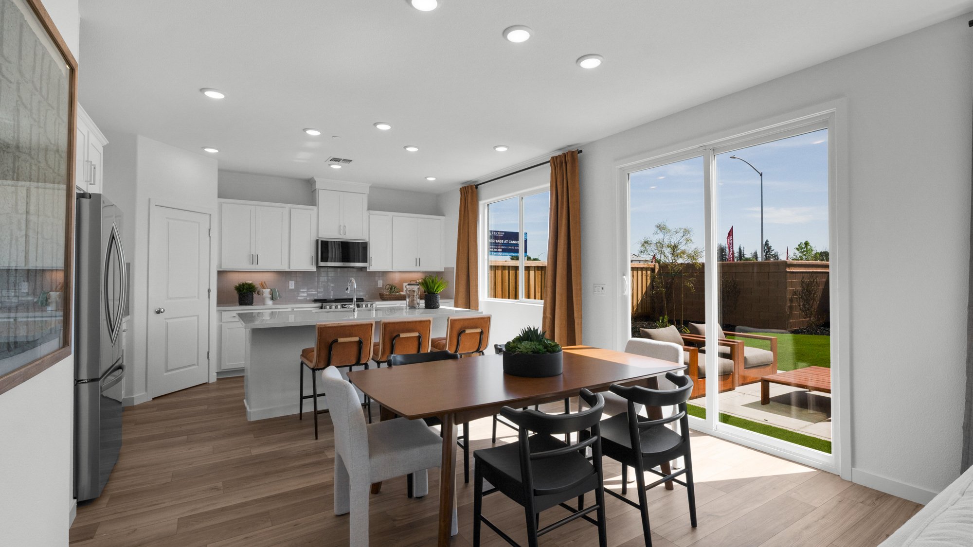 A kitchen with a dining table and chairs.