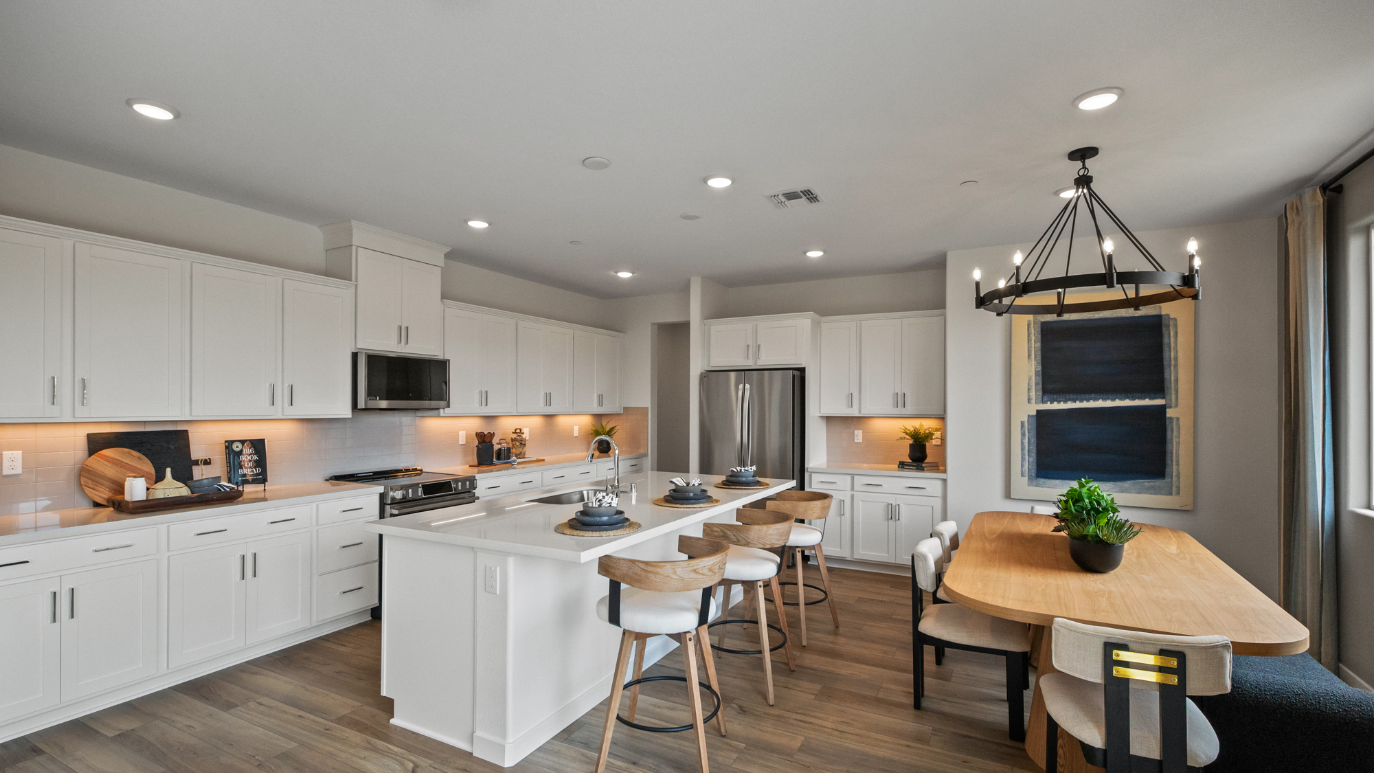 A kitchen with white cabinets.