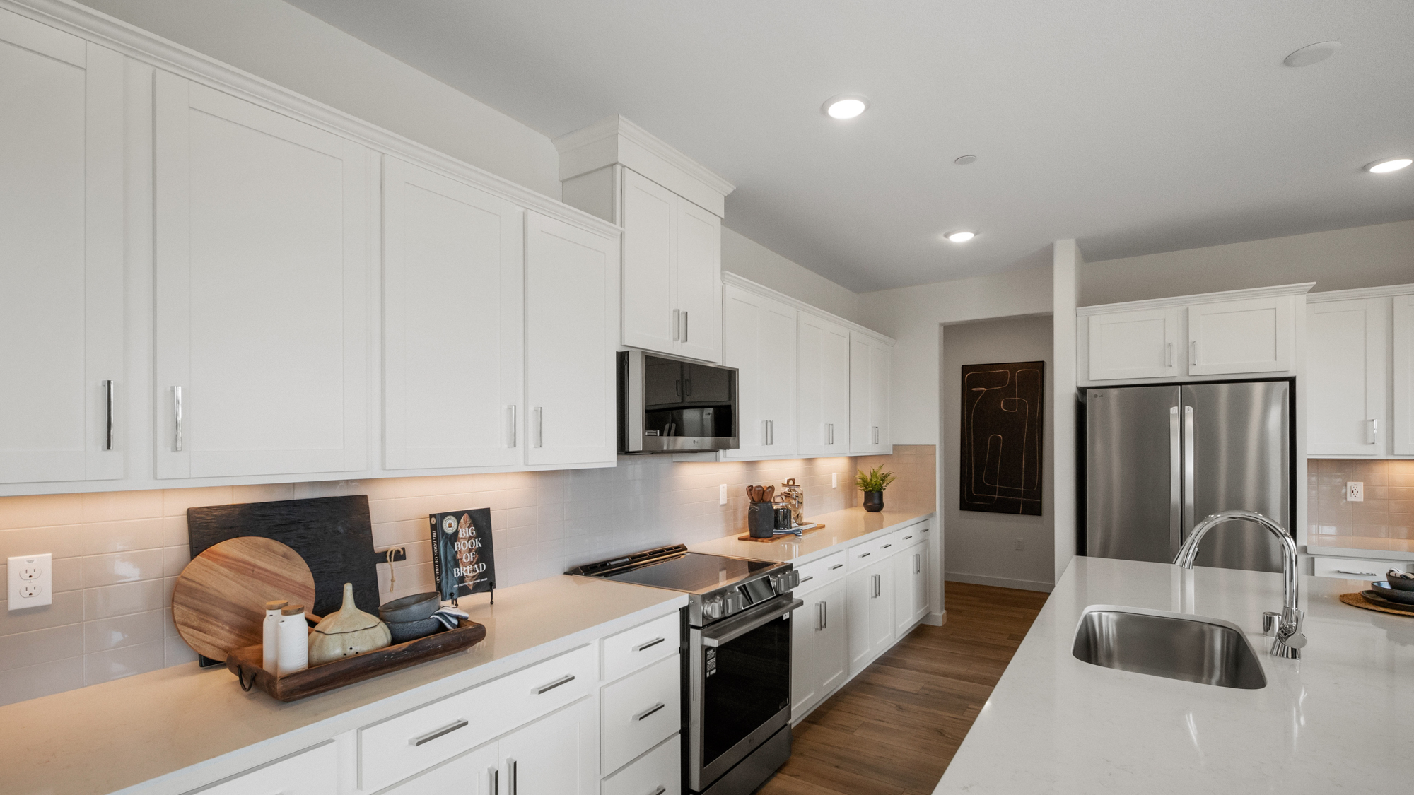 A kitchen with white cabinets.