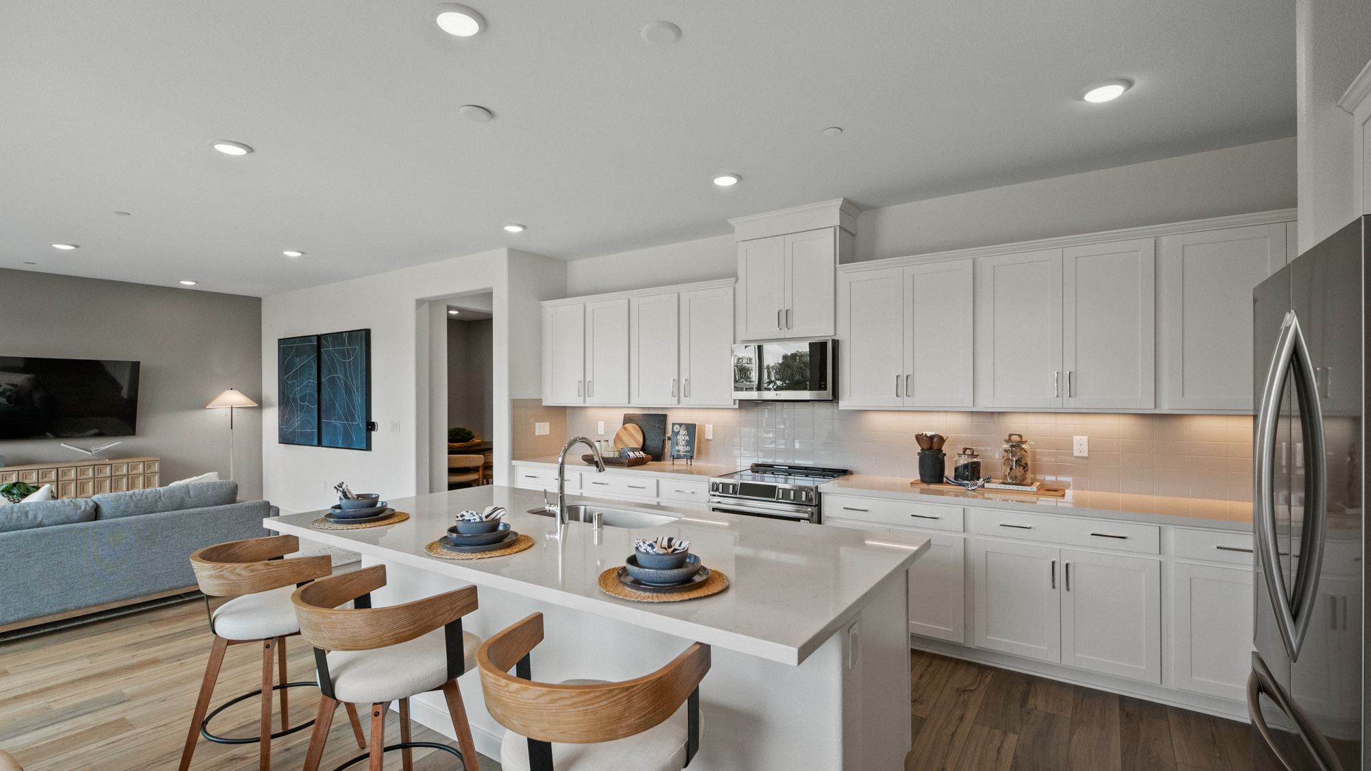 A kitchen with white cabinets.