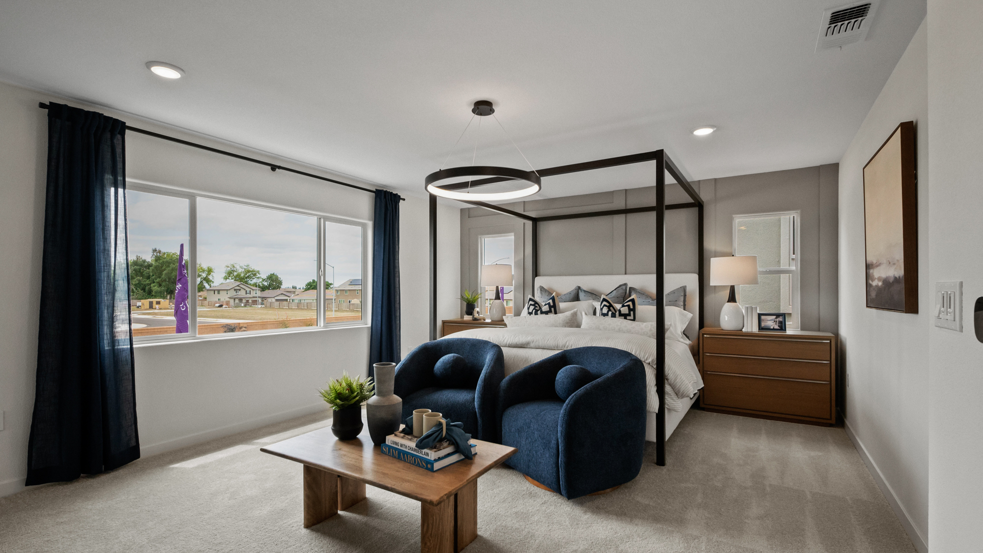 A bedroom with a large window.