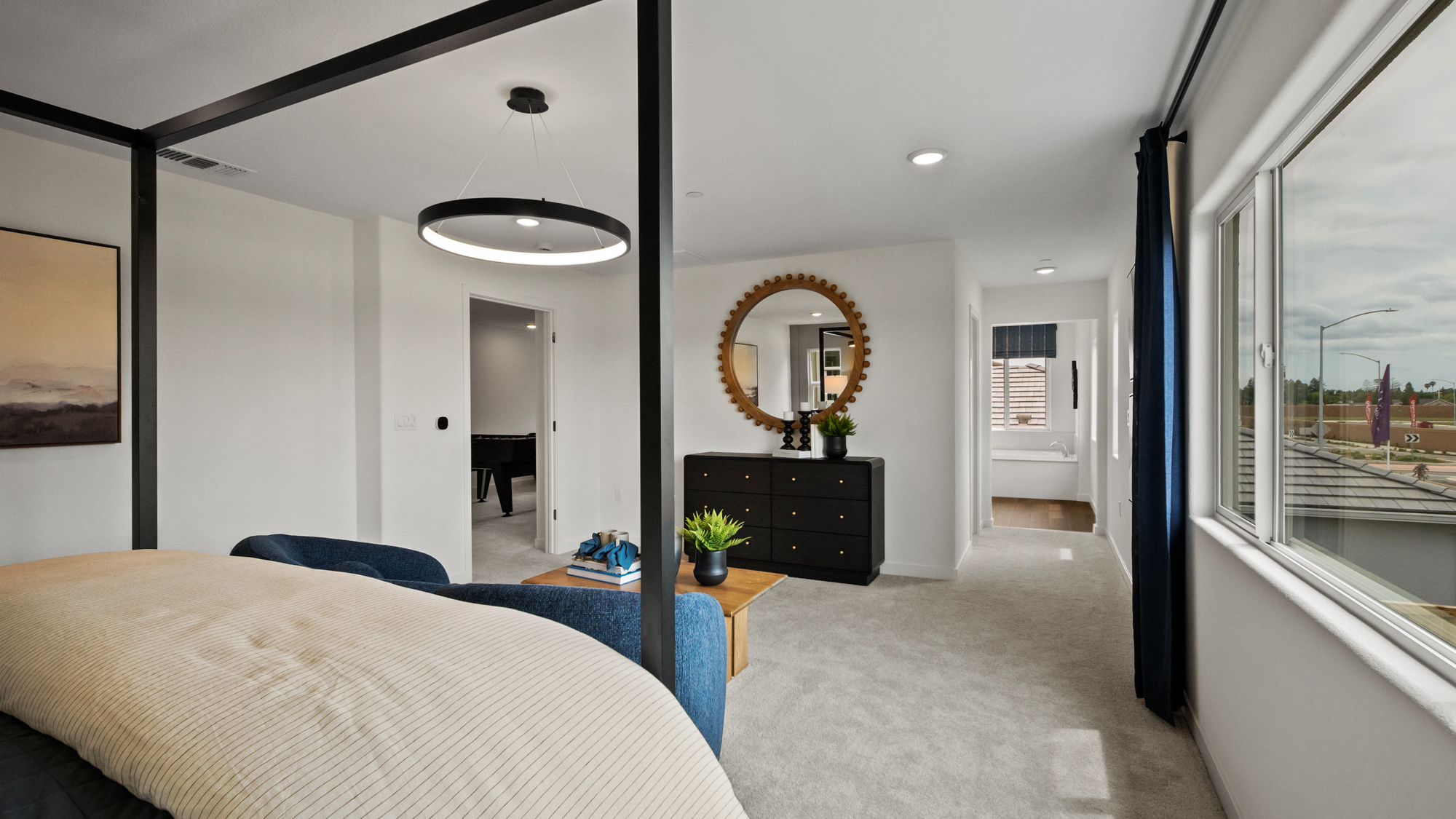 A bedroom with a large window.