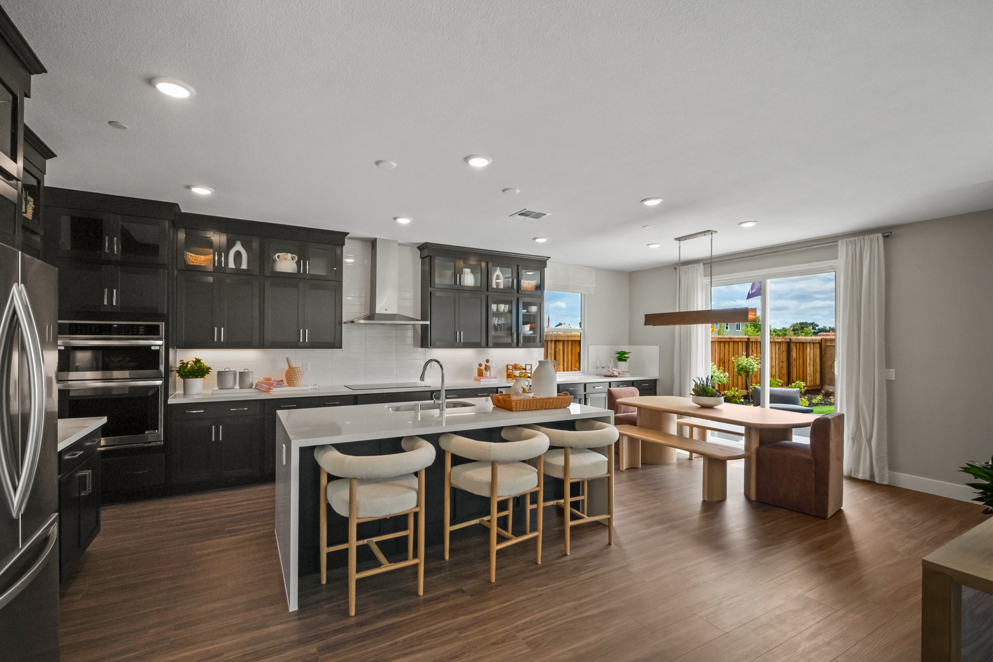 A kitchen with black cabinets.