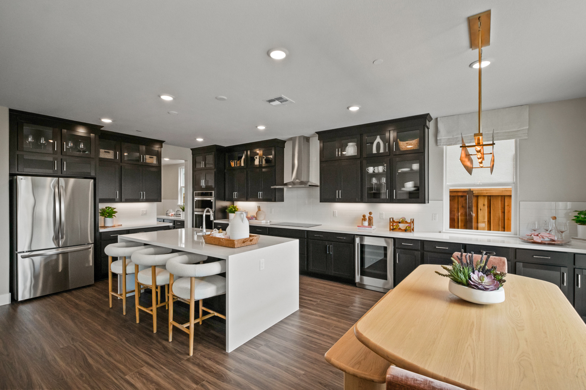 A kitchen with a table and chairs.