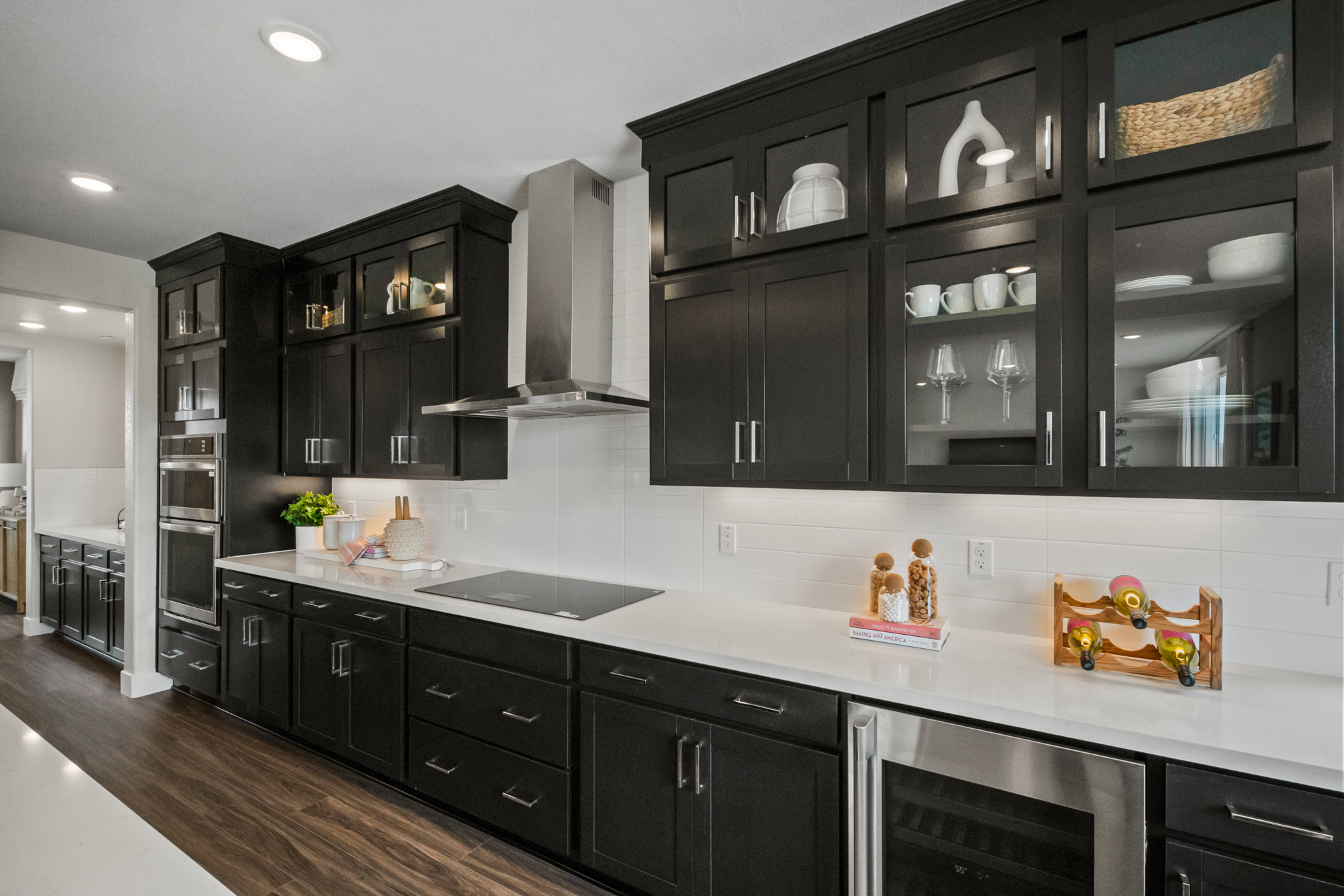 A kitchen with black cabinets.