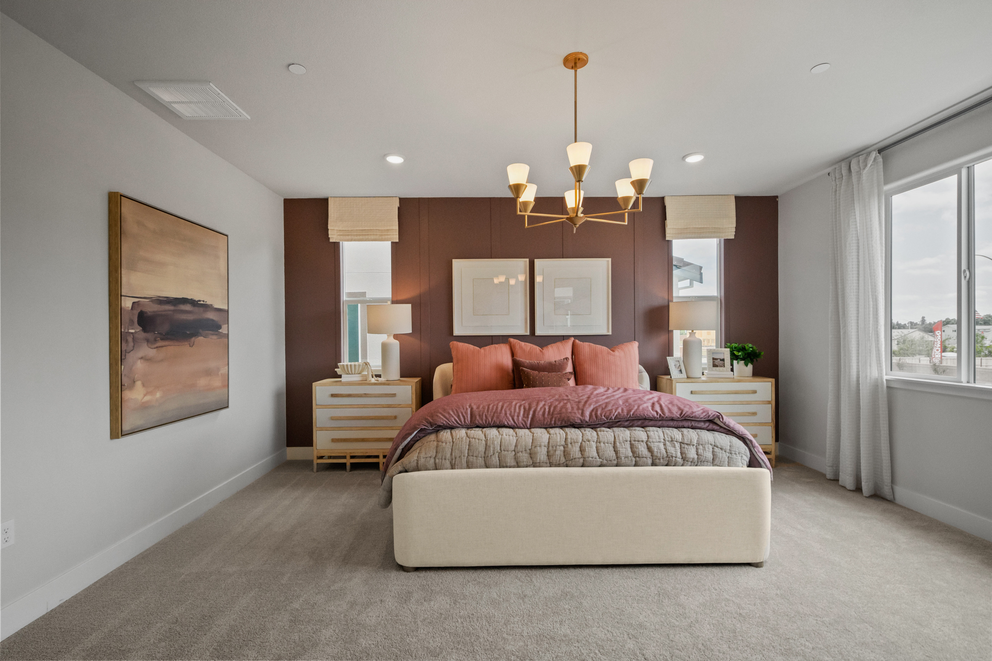 A bedroom with a bed and a bench.