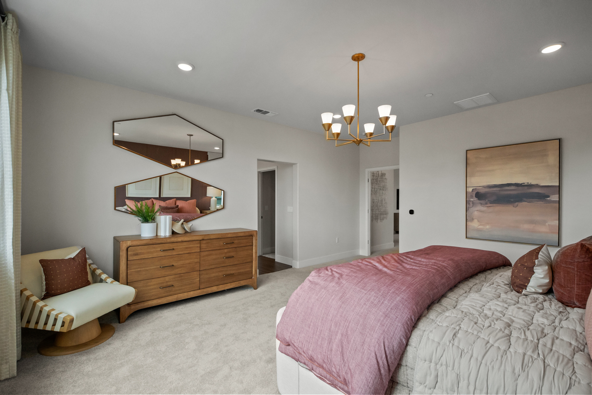 A bedroom with a pink bed and a pink blanket.