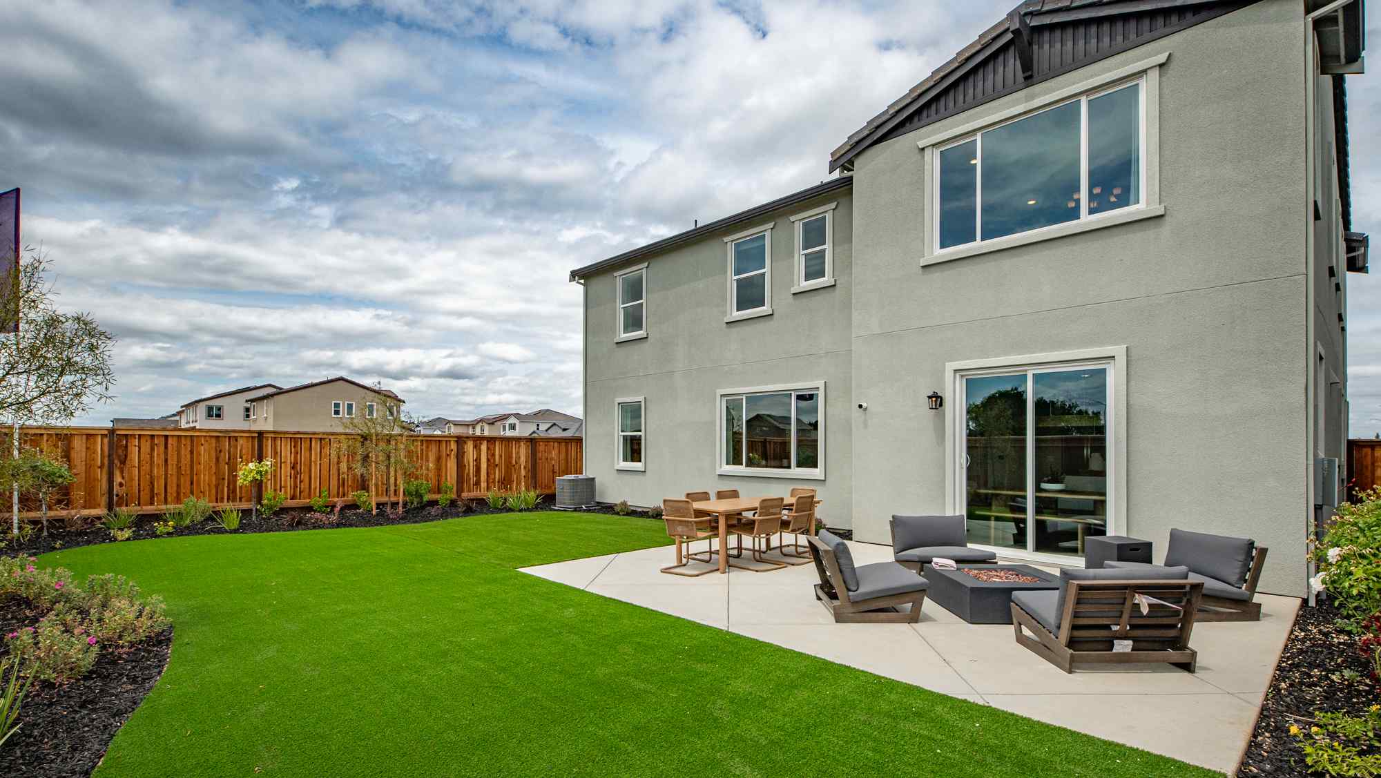 A house with a lawn and chairs.