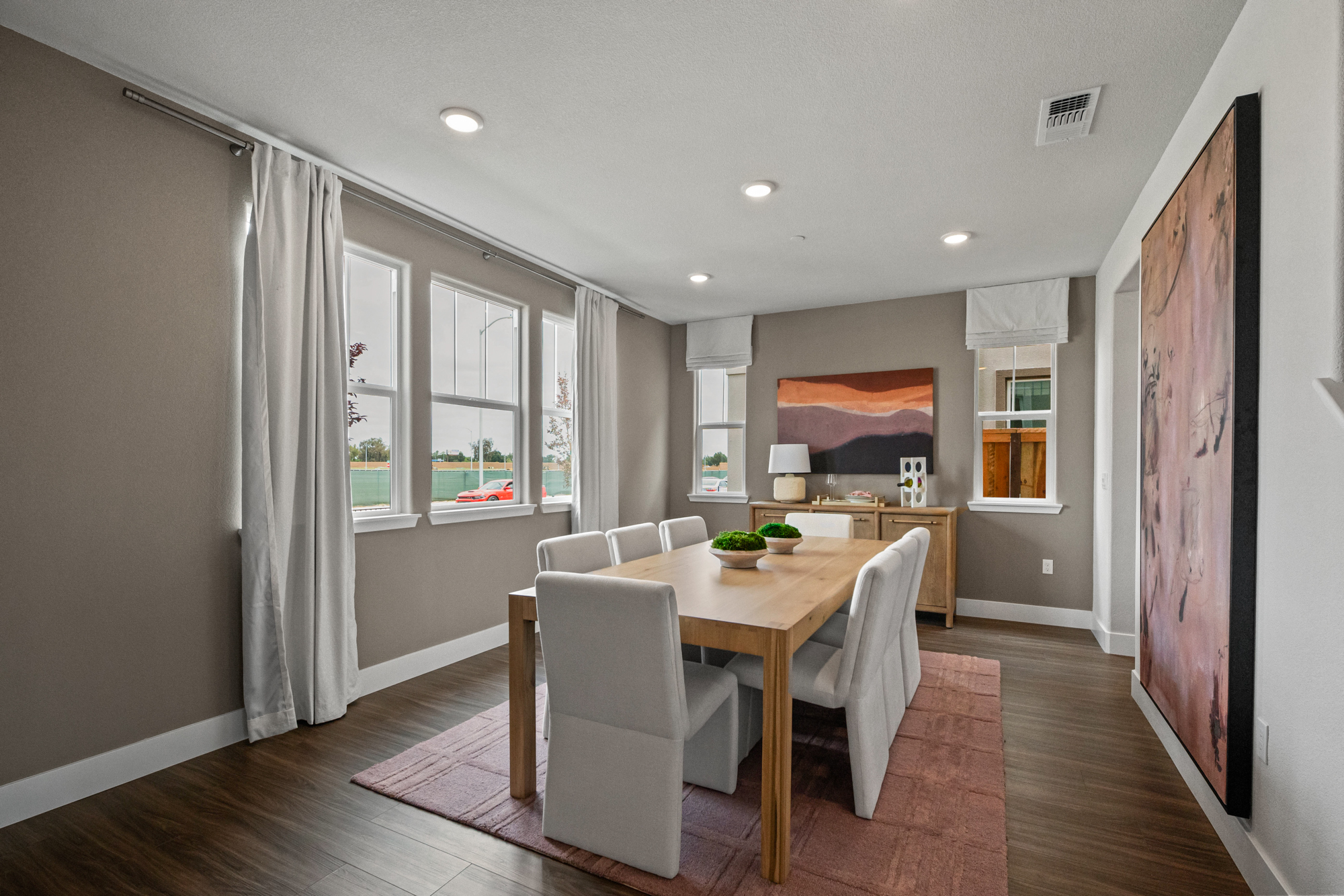 A dining room with a large table.