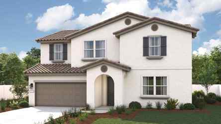A house with a garage and a lawn in front of it.