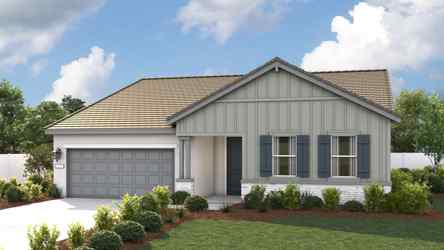 A house with a garage and a lawn in front of it.