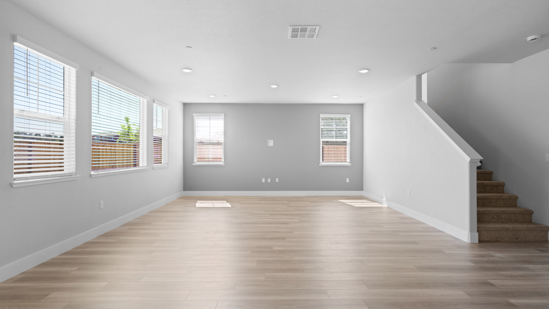 A room with a wood floor and windows.