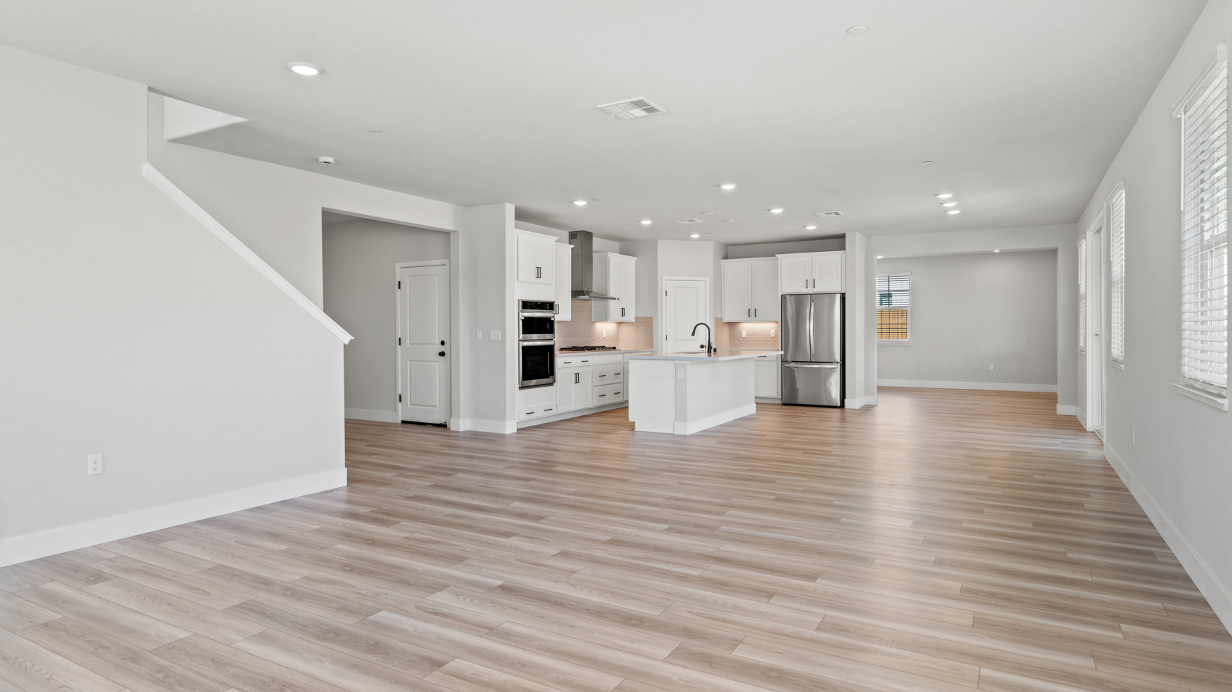 A large kitchen with white walls.