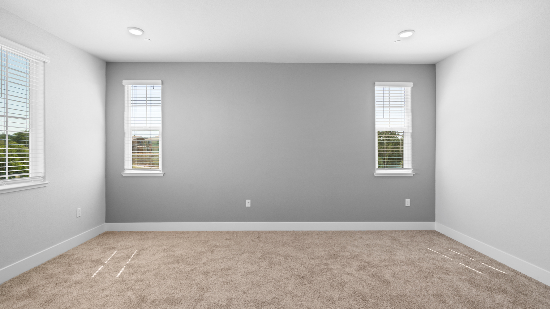 A room with windows and carpet.