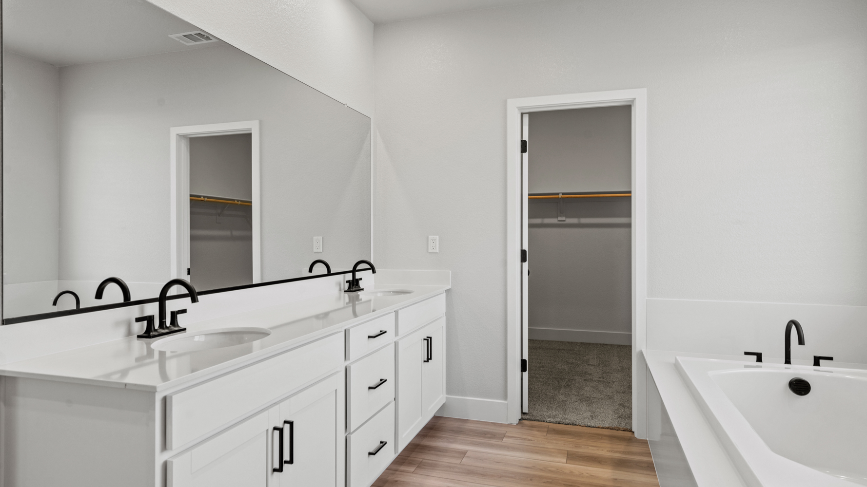 A bathroom with white cabinets.