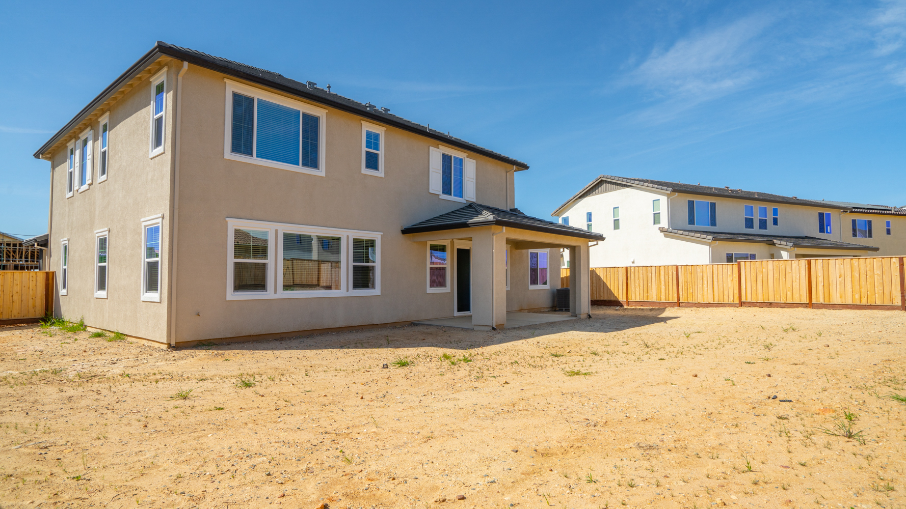 A house with a dirt yard.