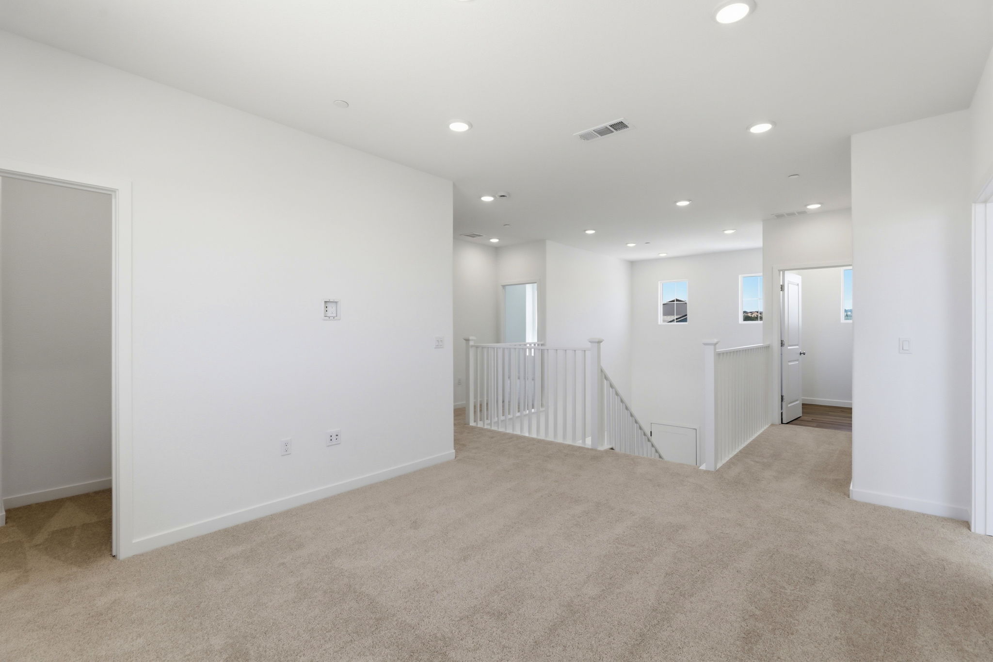 A hallway with white walls.
