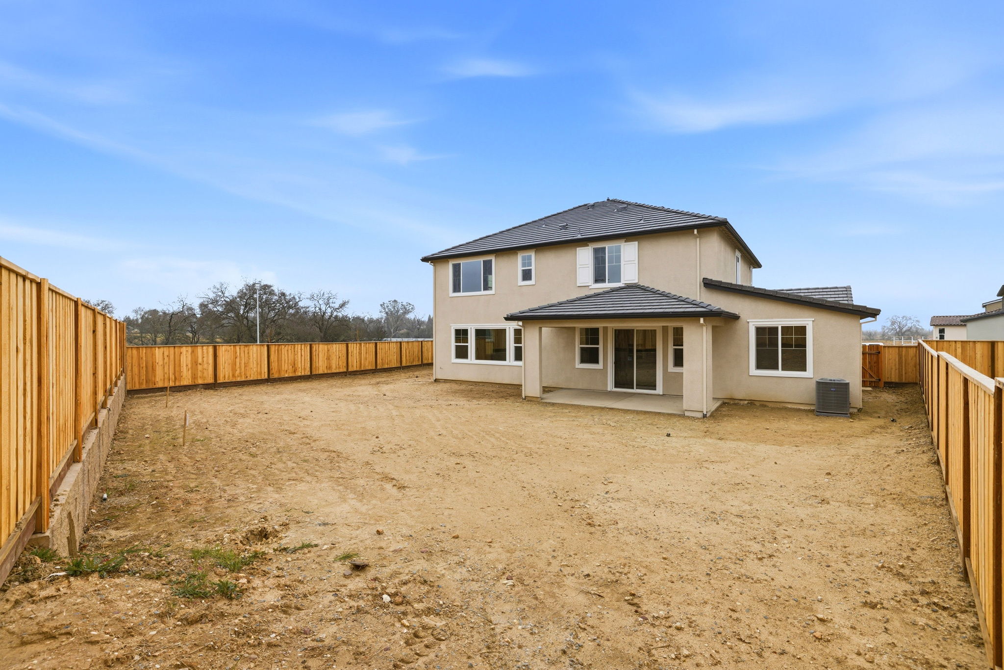 A house in a dirt field.