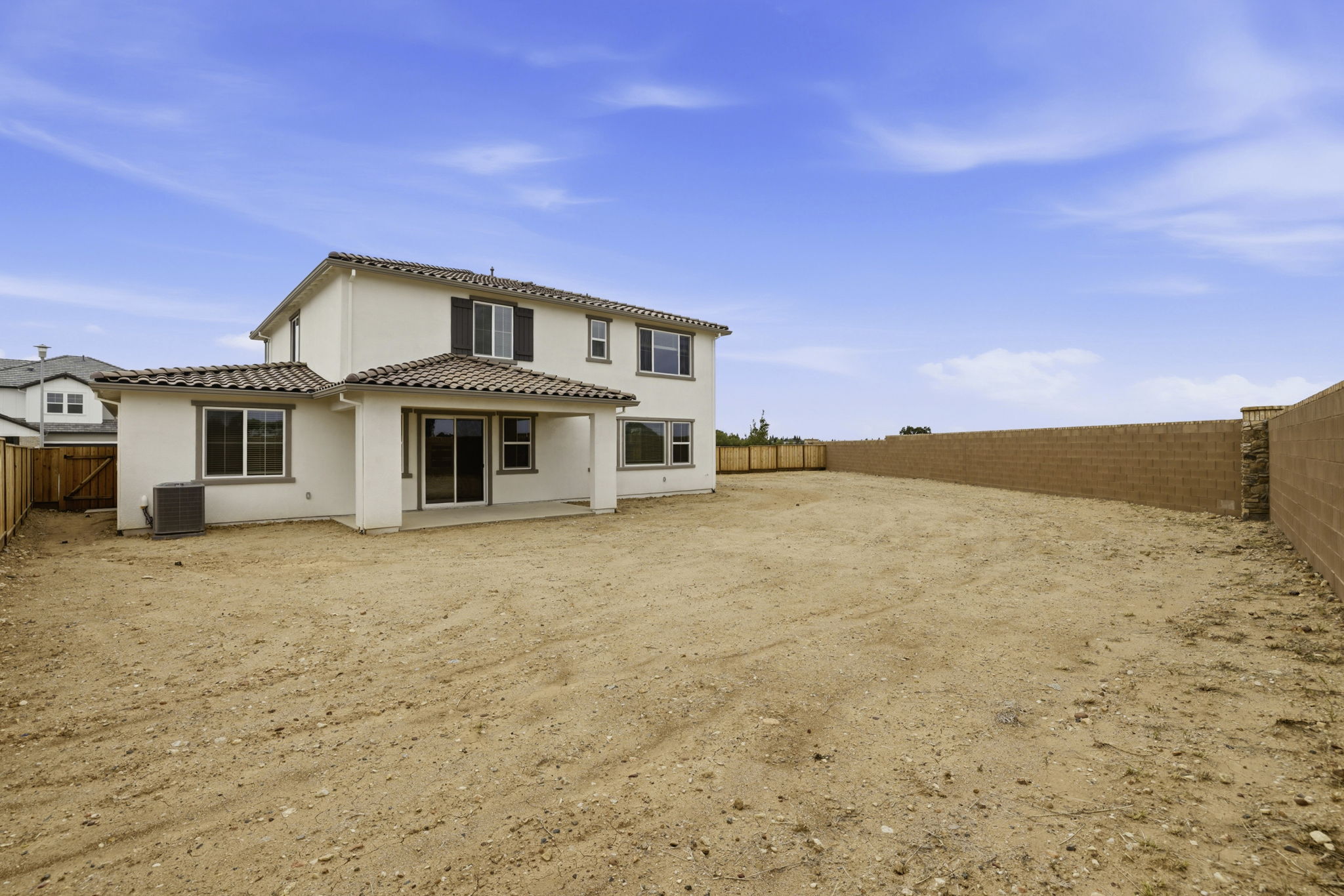 A house in a dirt field.