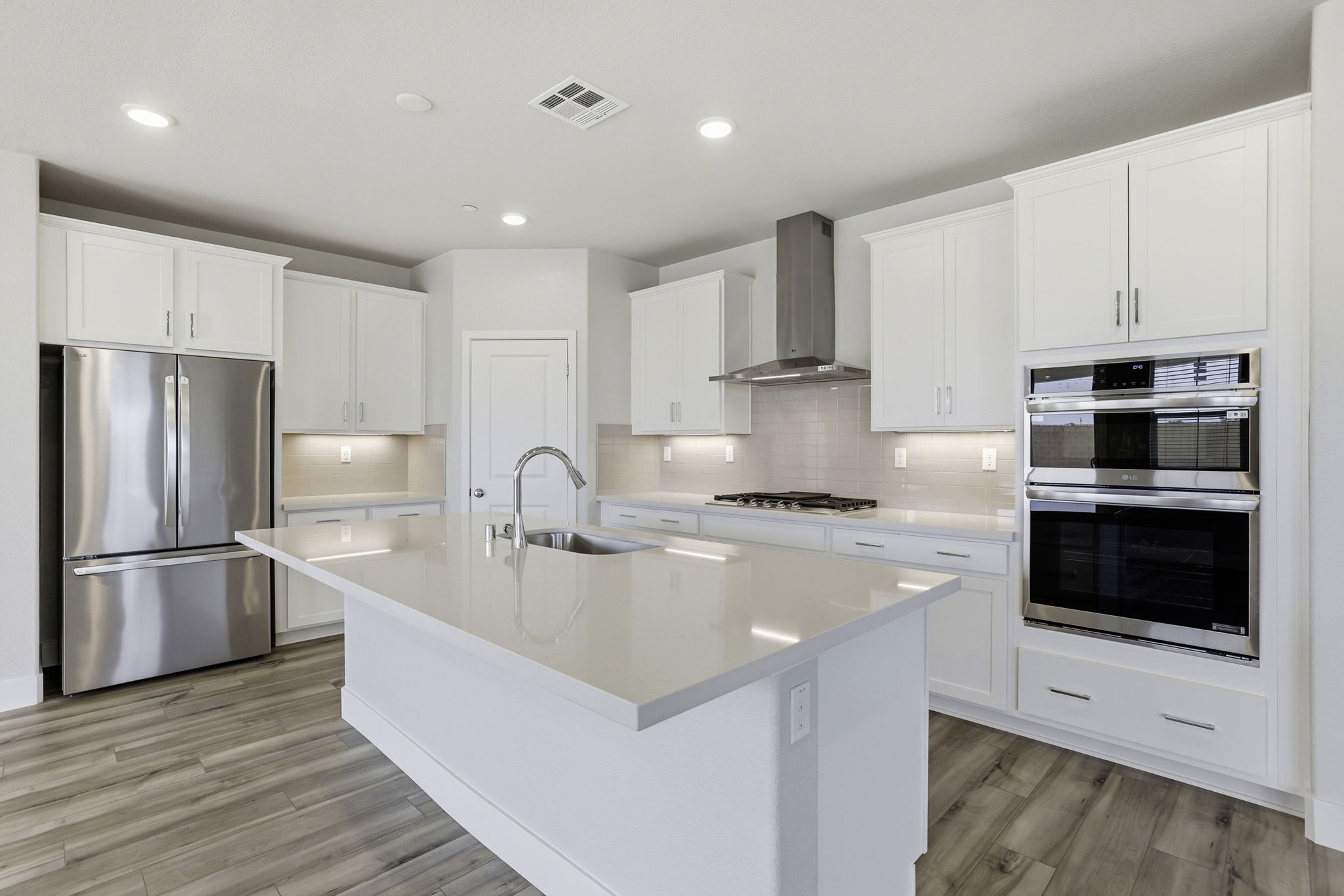 A kitchen with white cabinets.