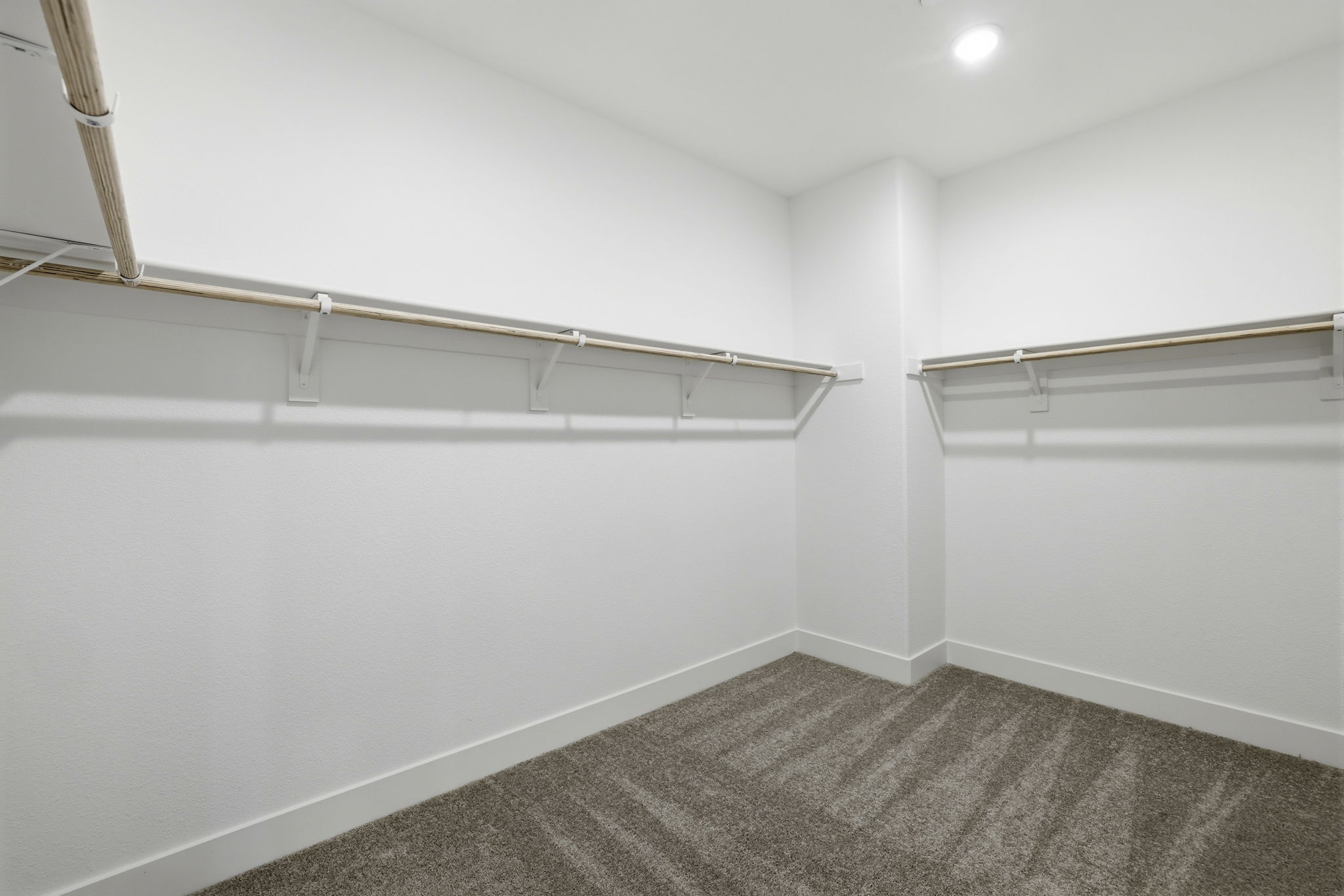 A white wall with a metal railing.
