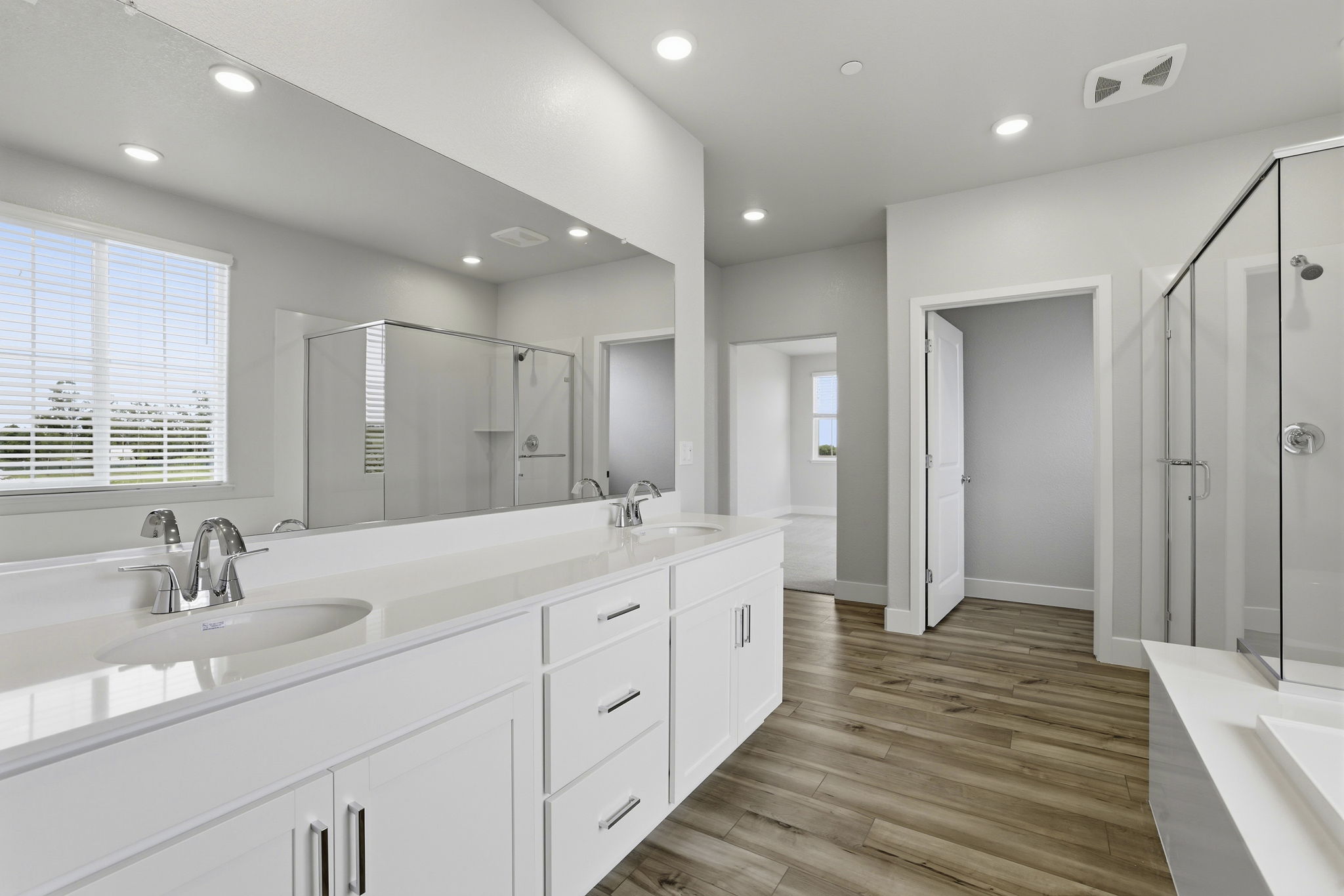 A bathroom with white cabinets.